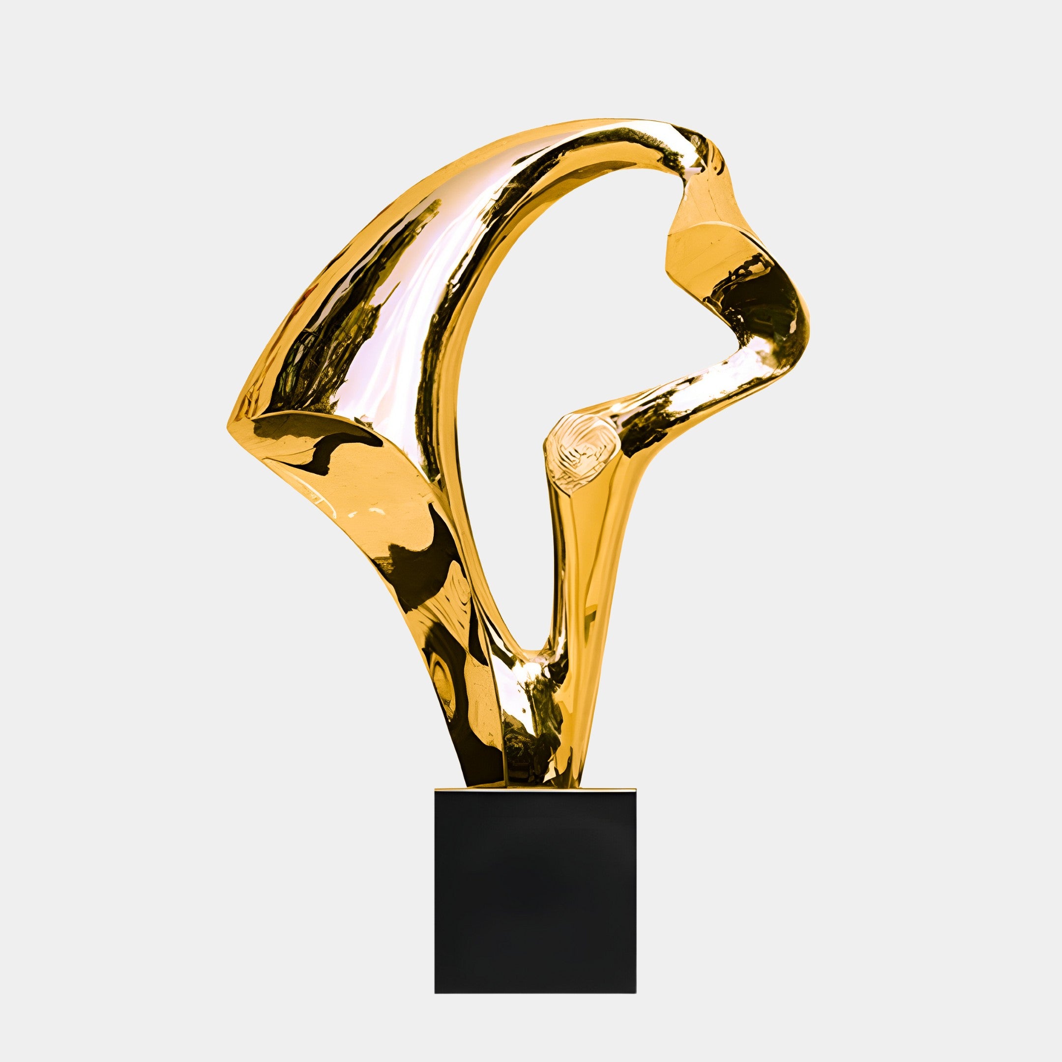 A golden abstract sculpture featuring smooth, flowing curves, mounted on a black base.