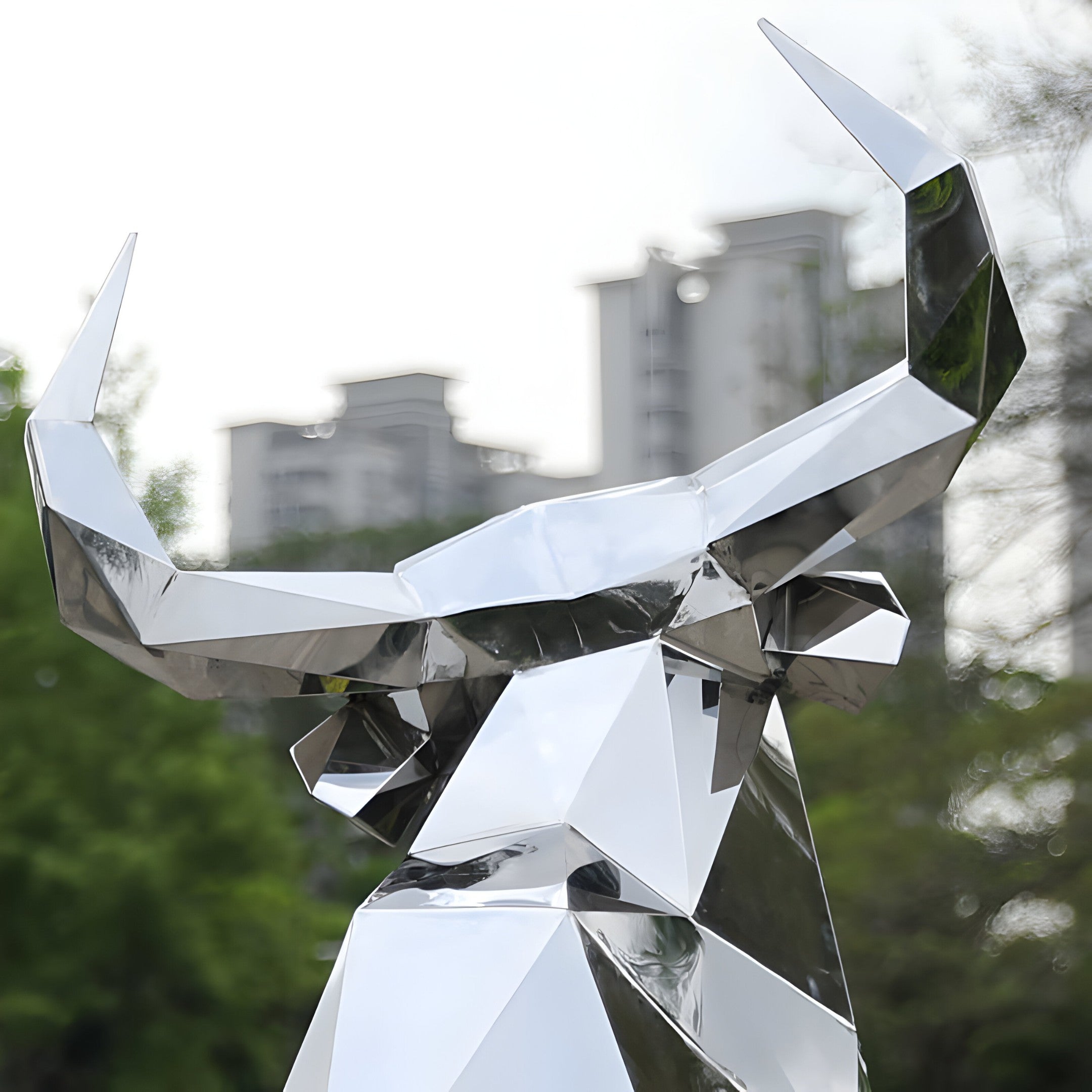 Close-up detail of a metallic bull sculpture, highlighting the angular facets and reflective surfaces of the modern artwork.