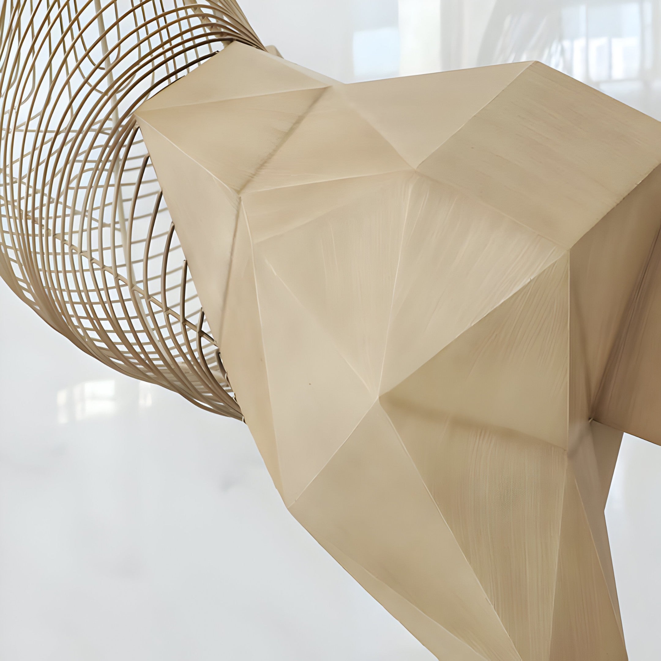 Close-up image highlighting the geometric facets and delicate wire construction of the sculpture’s body.