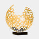 Sculpture made from gold-plated interlocking gears forming a partial sphere, mounted on a black base.