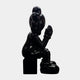 The Ex-Display Midnight Black Iconify Melancholy Sitting Sculpture by Giant Sculptures features a 130cm glossy resin figure with large, rounded cartoon-like features seated on a block, hand on chin, embodying minimalist artistry.