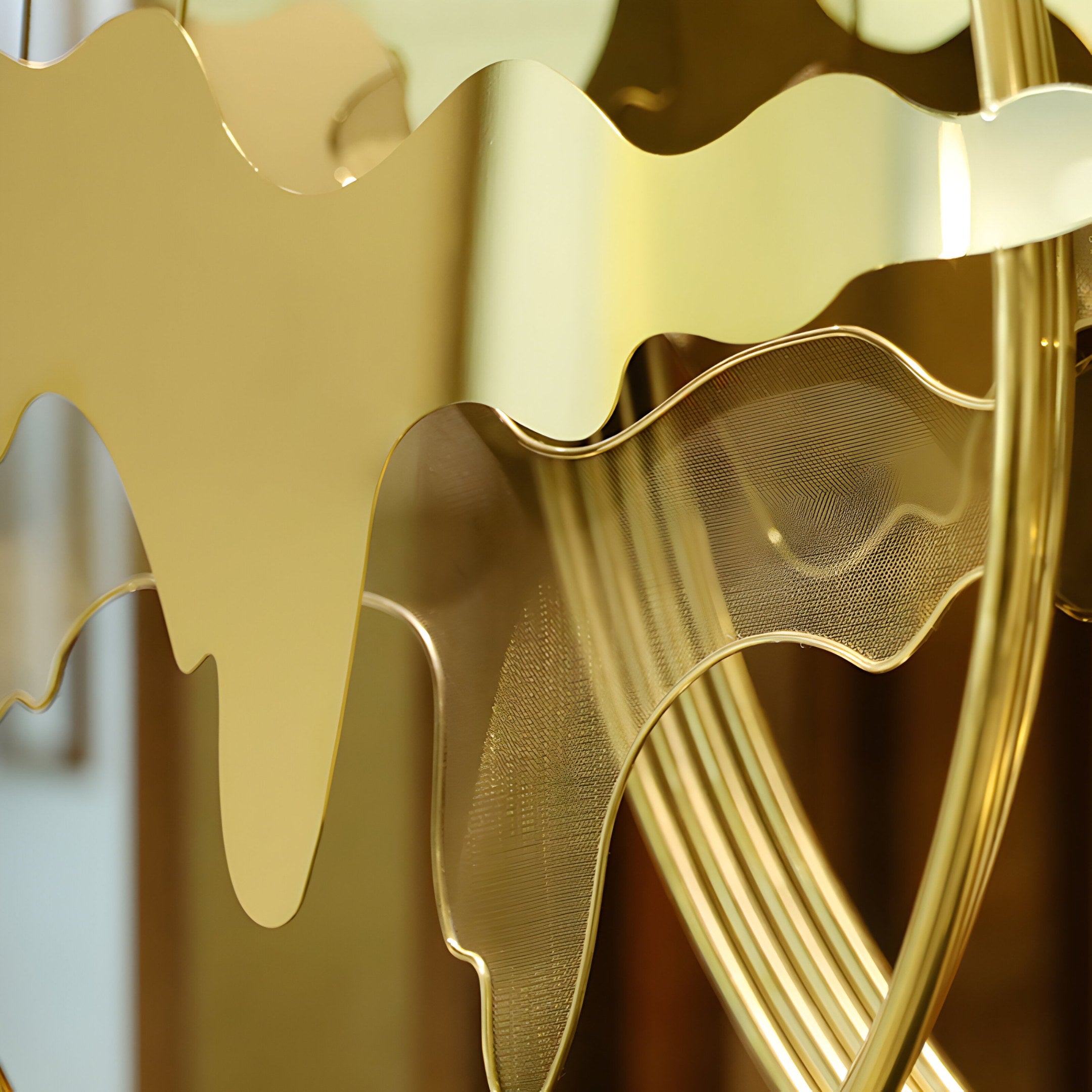 A detailed close-up of the Horizon Gold Abstract Sculpture showcasing its reflective gold wave-like forms.