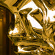 A detailed view of the polished gold surface of the stainless steel sculpture, highlighting the intricate texture and reflective qualities. Perfect for enhancing luxurious, modern décor settings.