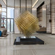 Matrix Gold Geometric Sculpture displayed in a high-end indoor setting, reflecting light and adding a touch of luxury to the space.