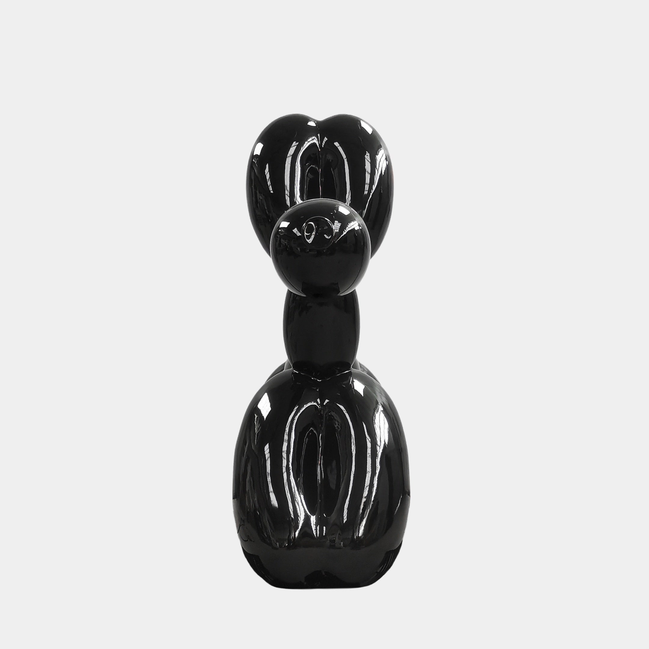 The Onyx Black Balloon Dog Sculpture by Giant Sculptures captures contemporary art in a sleek, abstract design, its glossy black finish contrasting strikingly against a white background.