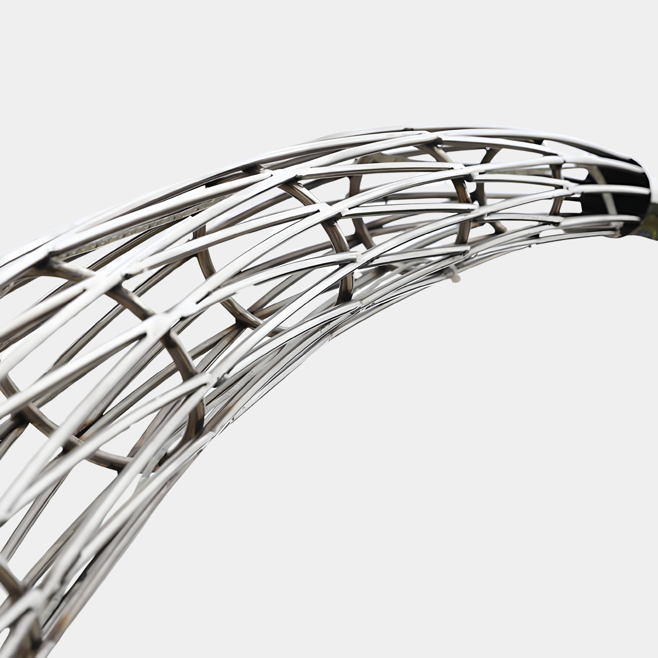 Close-up view of the silver sculpture’s intricate and reflective weave pattern.