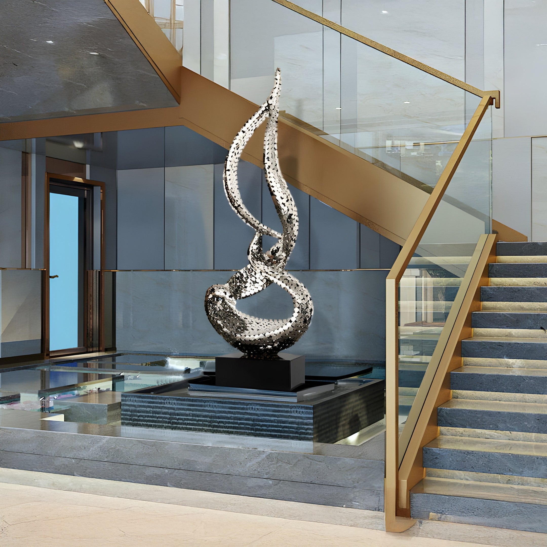 The silver flame sculpture featured near a stylish staircase in a modern, open-plan environment.