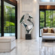 Silver organic sculpture styled in a bright modern living space with large glass windows, creating an airy atmosphere.