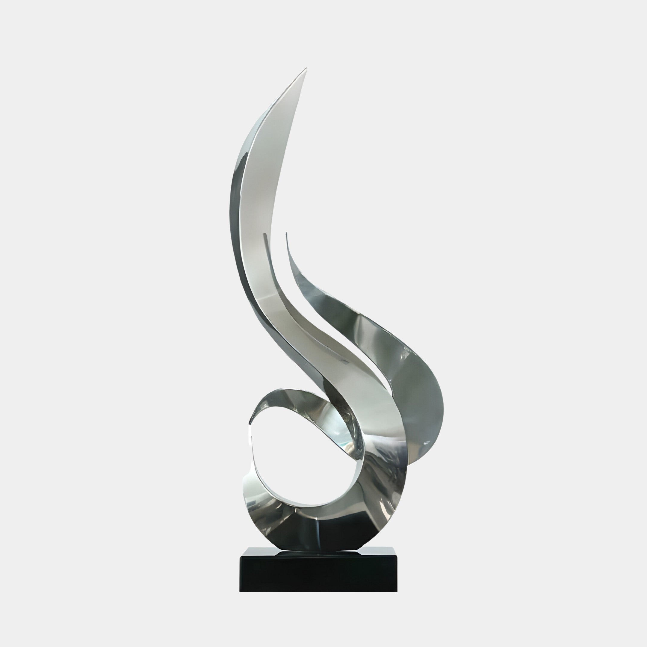 A silver sculpture featuring a fluid, curved form, mounted on a black base.