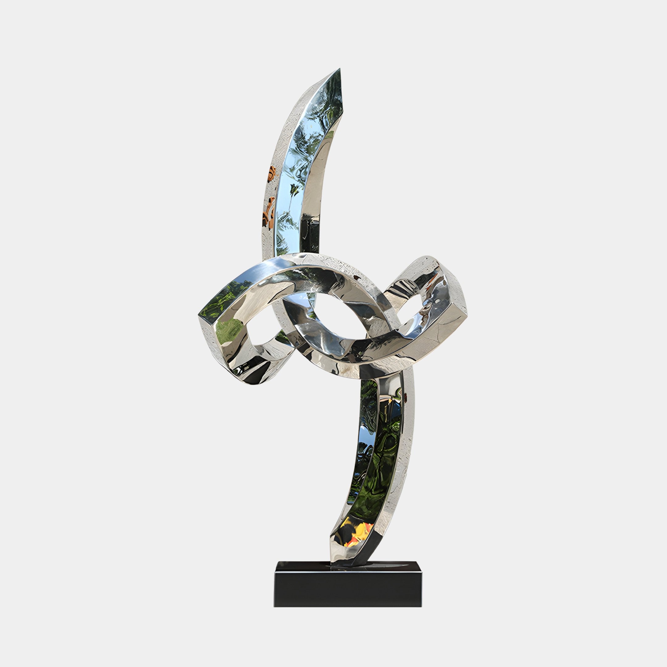 Infinity Twist abstract stainless steel sculpture with intertwining loops placed on a black base, reflecting light and offering a contemporary art piece for modern interiors or gardens.