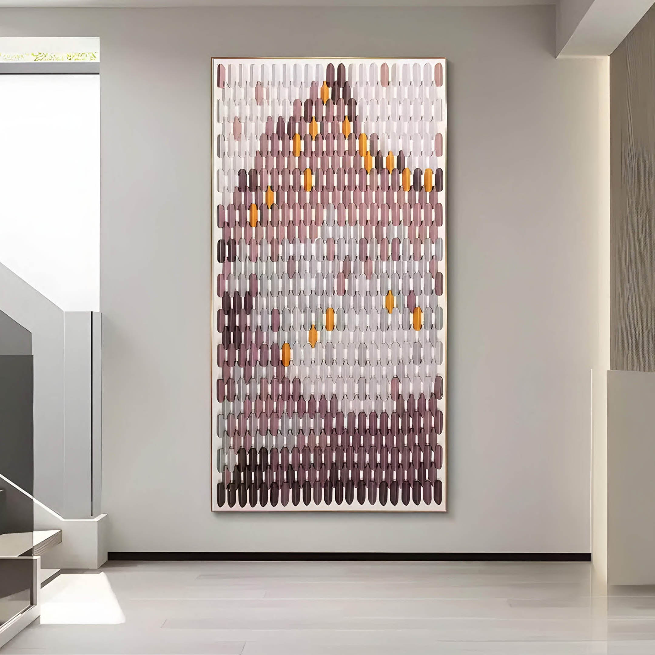 The Artevo 3D Ceramic Wall Art by Giant Sculptures, showcasing plum and amber tones with rows of elongated shapes, adds a serene abstract landscape vibe to a modern minimalist room featuring light-colored walls and floors.