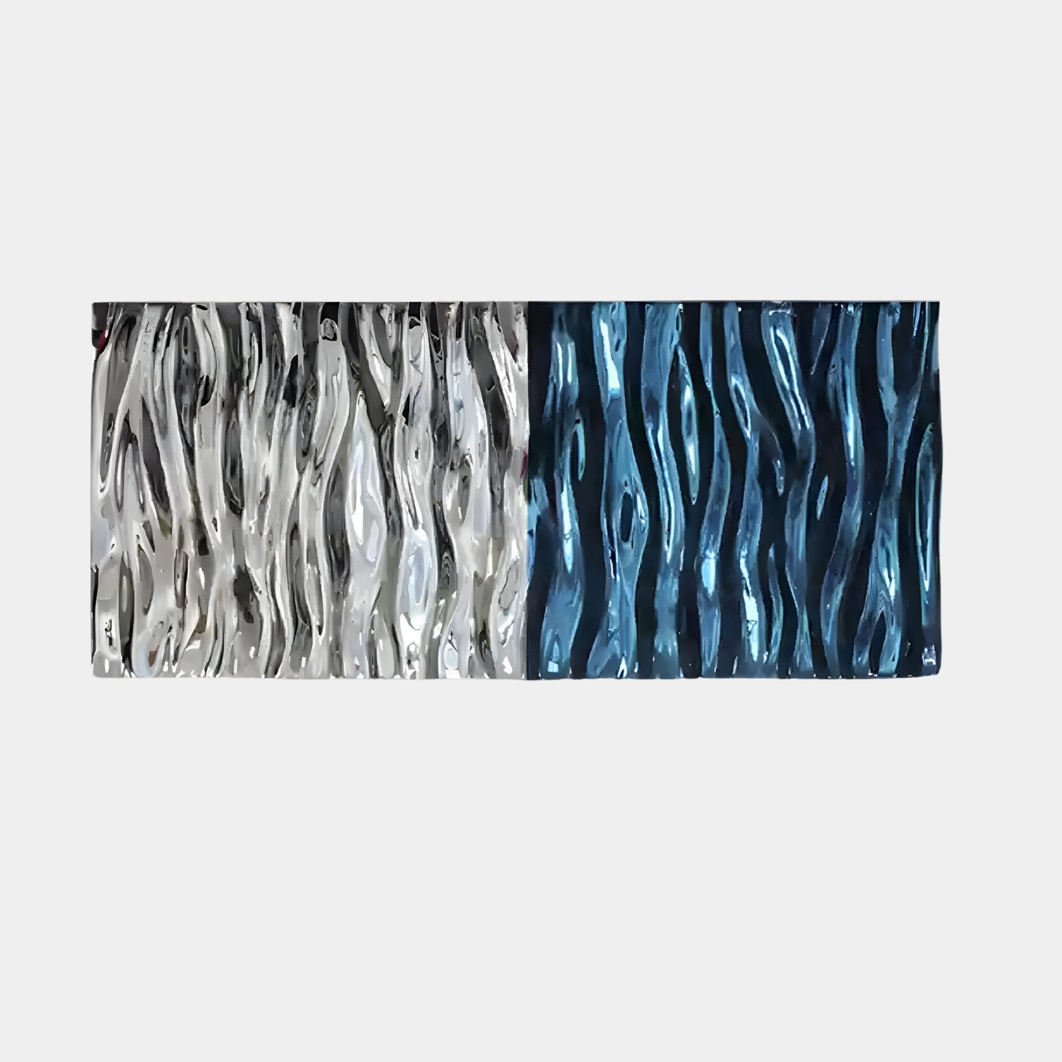 The Ripple Dual-Tone Chrome & Blue Textured Wall Art by Giant Sculptures features vertical wave-like patterns. Its abstract design showcases metallic textures, with the left glistening in silver and gray hues, shifting to deep blue on the right for a striking visual effect.