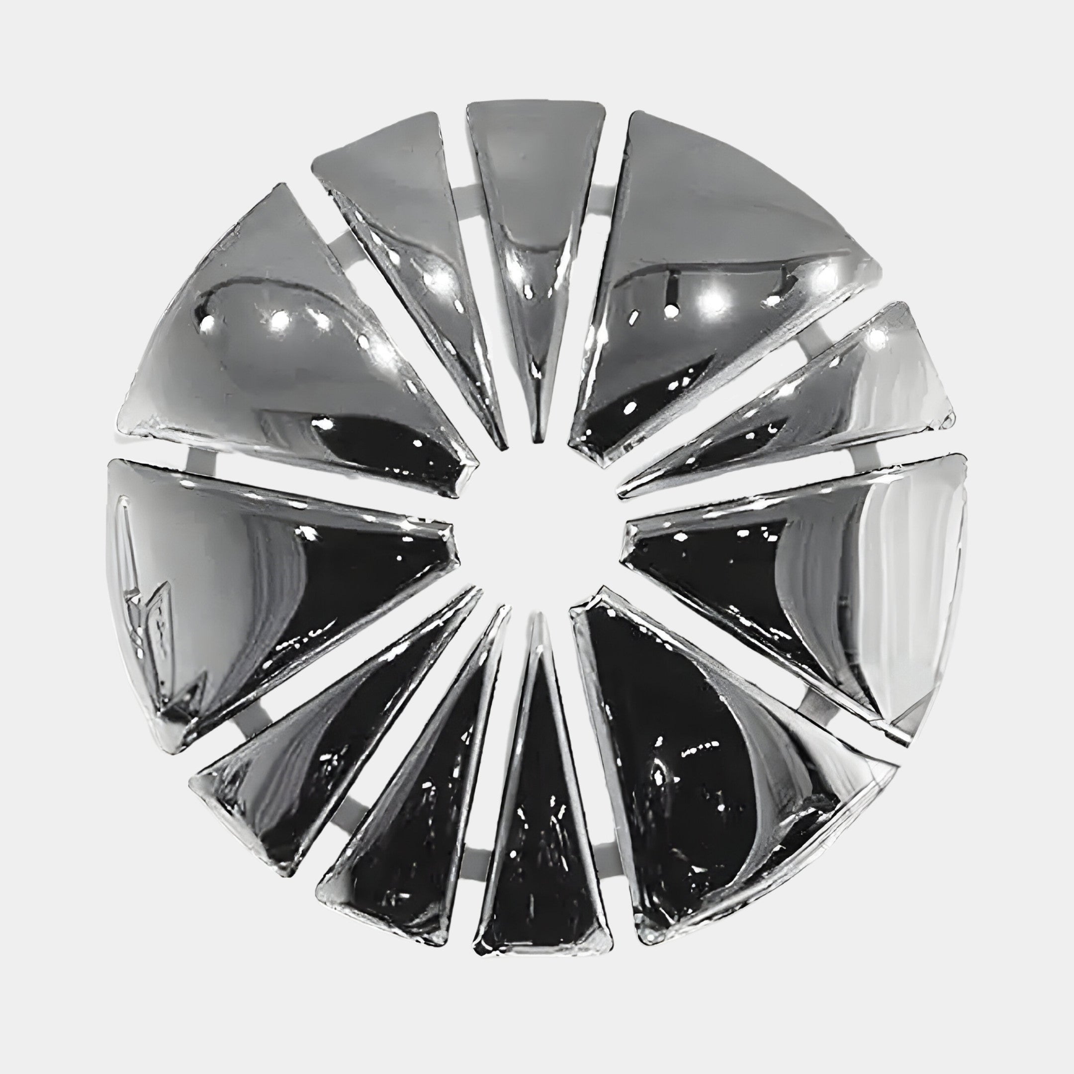 The Halo Chrome Segment Circle 3D Metal Wall Art by Giant Sculptures features a round, metallic design with radial triangular segments for a sunburst effect. Its reflective surface offers a sleek, modern appearance, ideal for enhancing contemporary interiors against white backgrounds.