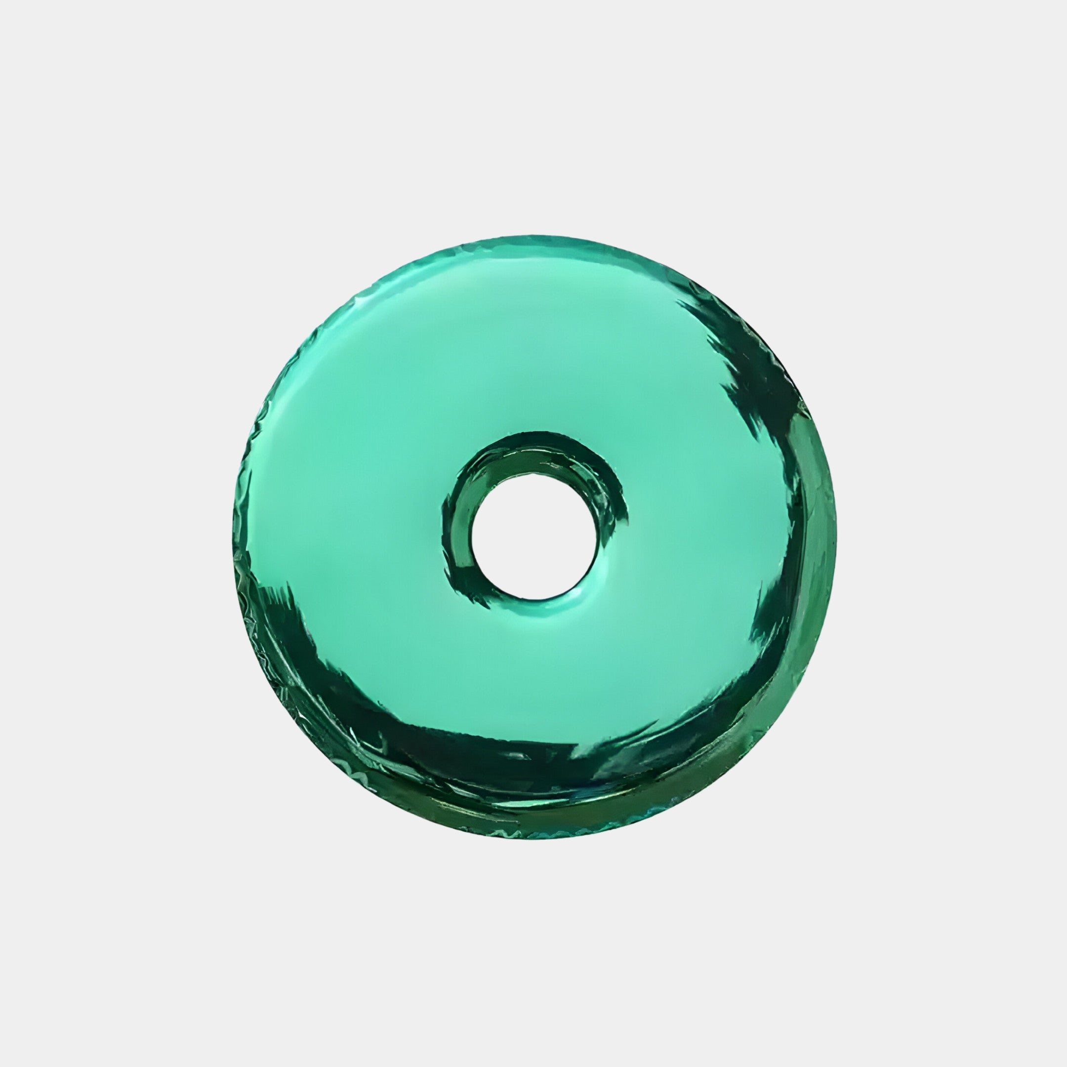 The Auro Emerald Round Gloss Metal 3D Wall Art by Giant Sculptures is displayed against a white background. It resembles a shiny, translucent green disc with a center hole, making it an exquisite piece for contemporary interiors.