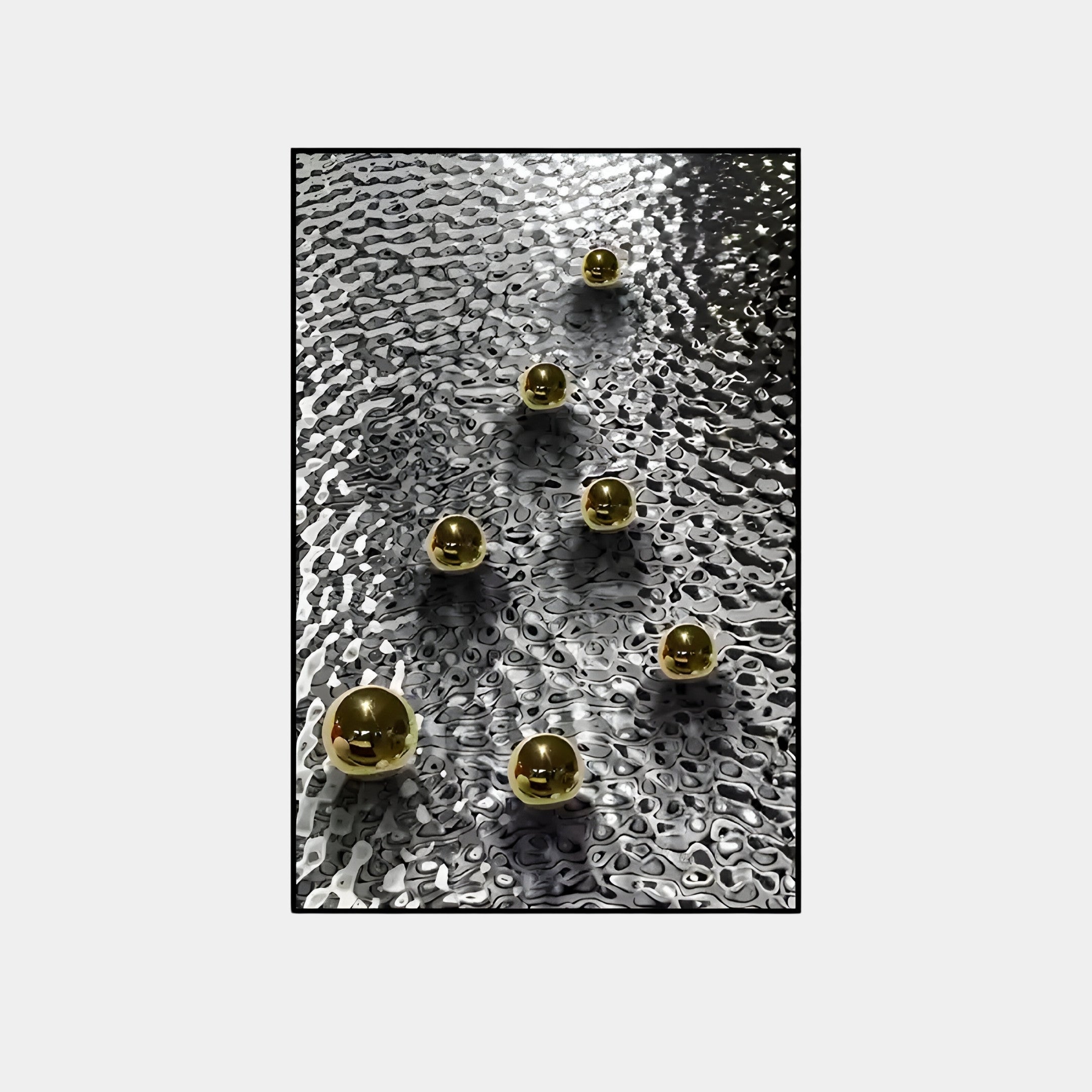 Luminosa Gold Orb Textured Metal Wall Art by Giant Sculptures features a cascade of golden spheres descending across a textured metallic surface. Reflections and shadows create a dynamic, wavy pattern, making it ideal for contemporary interiors.