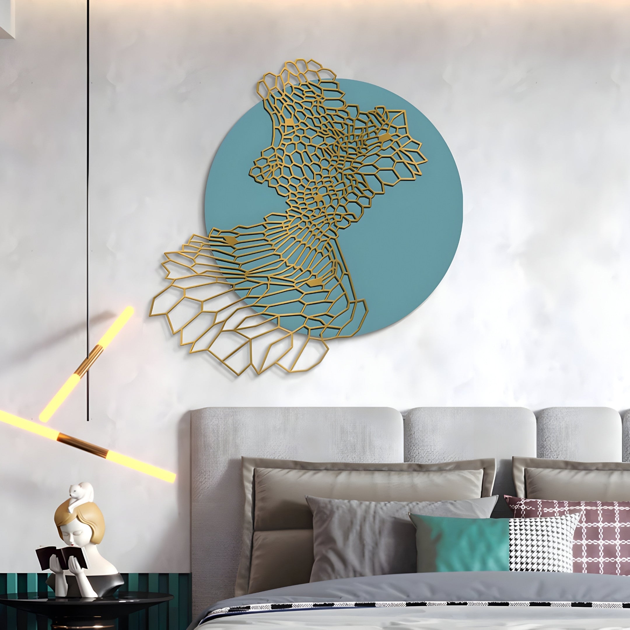 A modern bedroom features the Cellura Turquoise Geometric Layered Gold Wired Metal Wall Art by Giant Sculptures on a teal circular background, complemented by a grey upholstered headboard, decorative pillows, a mannequin sculpture on a side table, and a contemporary light fixture.