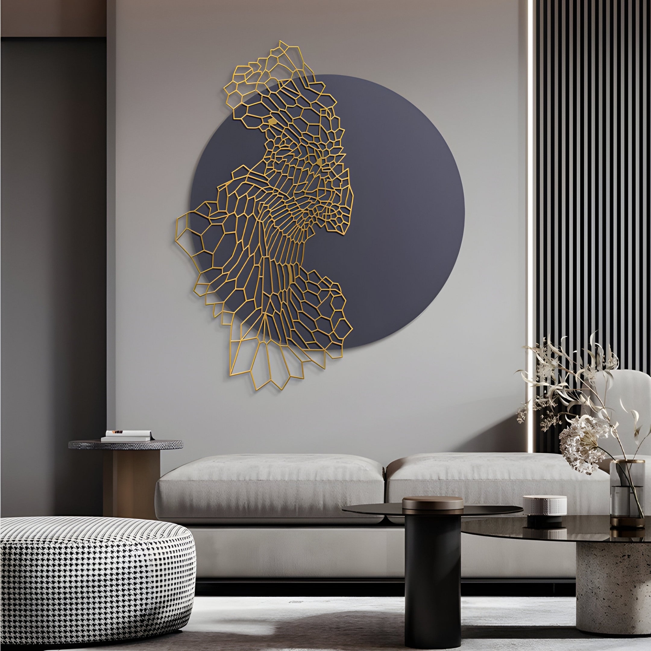 A modern living room showcases a light gray sofa, round coffee table, and Giant Sculptures Cellura Deep Purple Geometric Flow Gold Wired Metal Wall Art. A textured pouf sits in front with nearby dried florals, while vertical striped wall accents complete the décor.