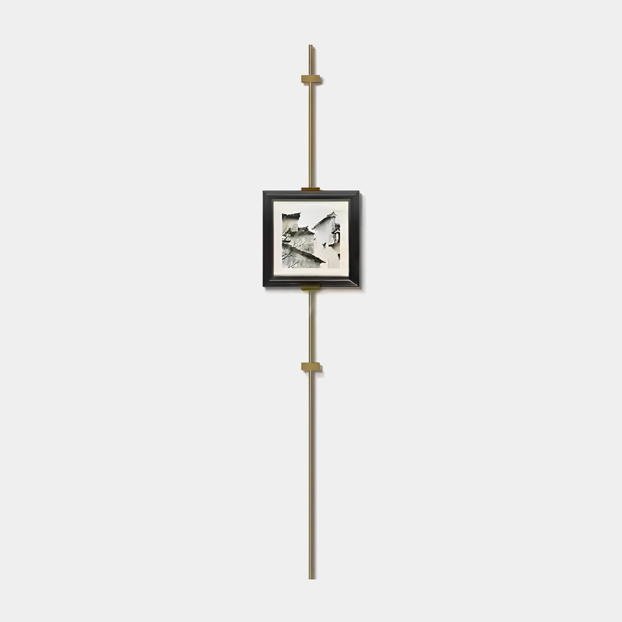 The Ecliptica Fragmented Geometric Gold Frame Wall Art by Giant Sculptures features a minimalist black and white framed photo mounted on a vertical gold rod with elegant brackets, set against a plain white background for an elegant geometric look.