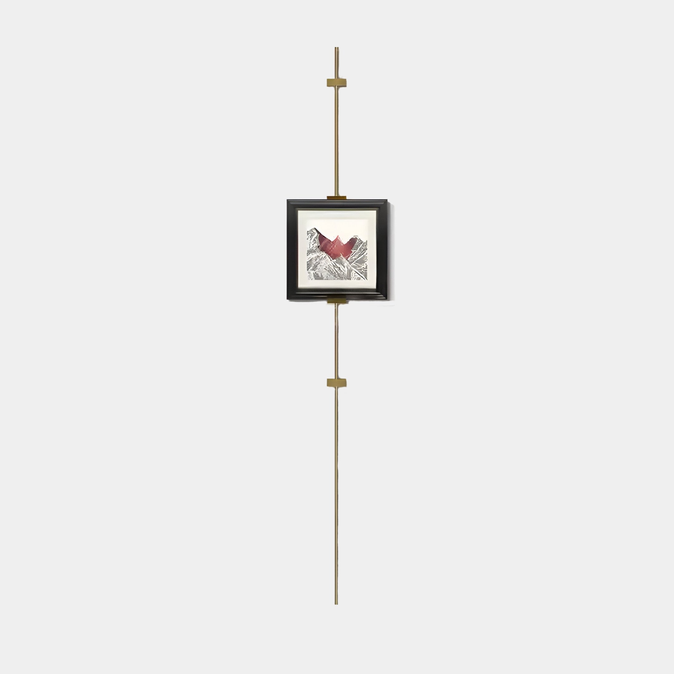 The Giant Sculptures Ecliptica Red Mountain Abstract Gold Frame Wall Art features a modern minimalist design with geometric patterns and a bold red shape on a black frame, suspended on a vertical golden rod. Ideal for contemporary interiors with plain backgrounds.