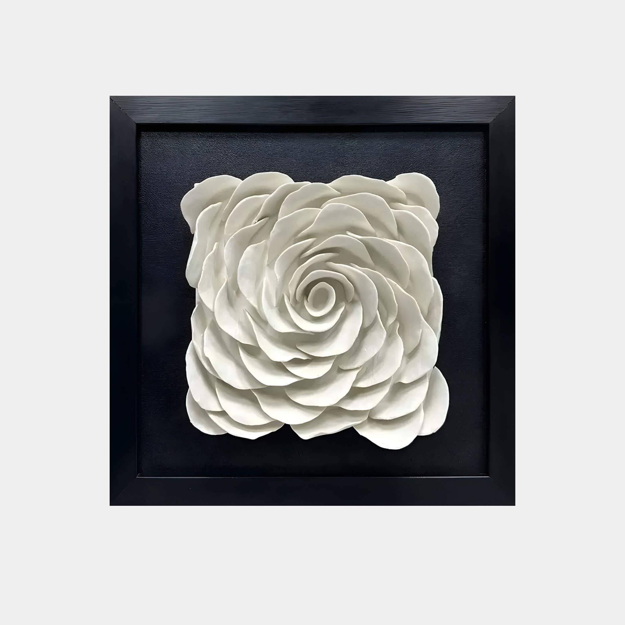 The Harmonia 3D Rose Wall Installation by Giant Sculptures features a white, layered floral design that spirals outward on a black background. Its simple black frame enhances the intricate details of this timeless and elegant piece.