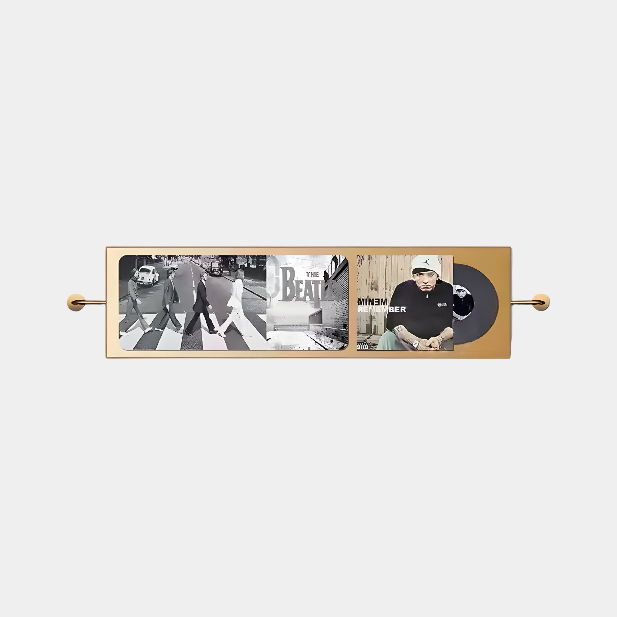 The Resonance Record Wall Art by Giant Sculptures beautifully showcases album covers of The Beatles Abbey Road and Eminems hip-hop masterpiece with a vinyl record, set in a sleek modern frame with metallic accents for a contemporary musical homage.