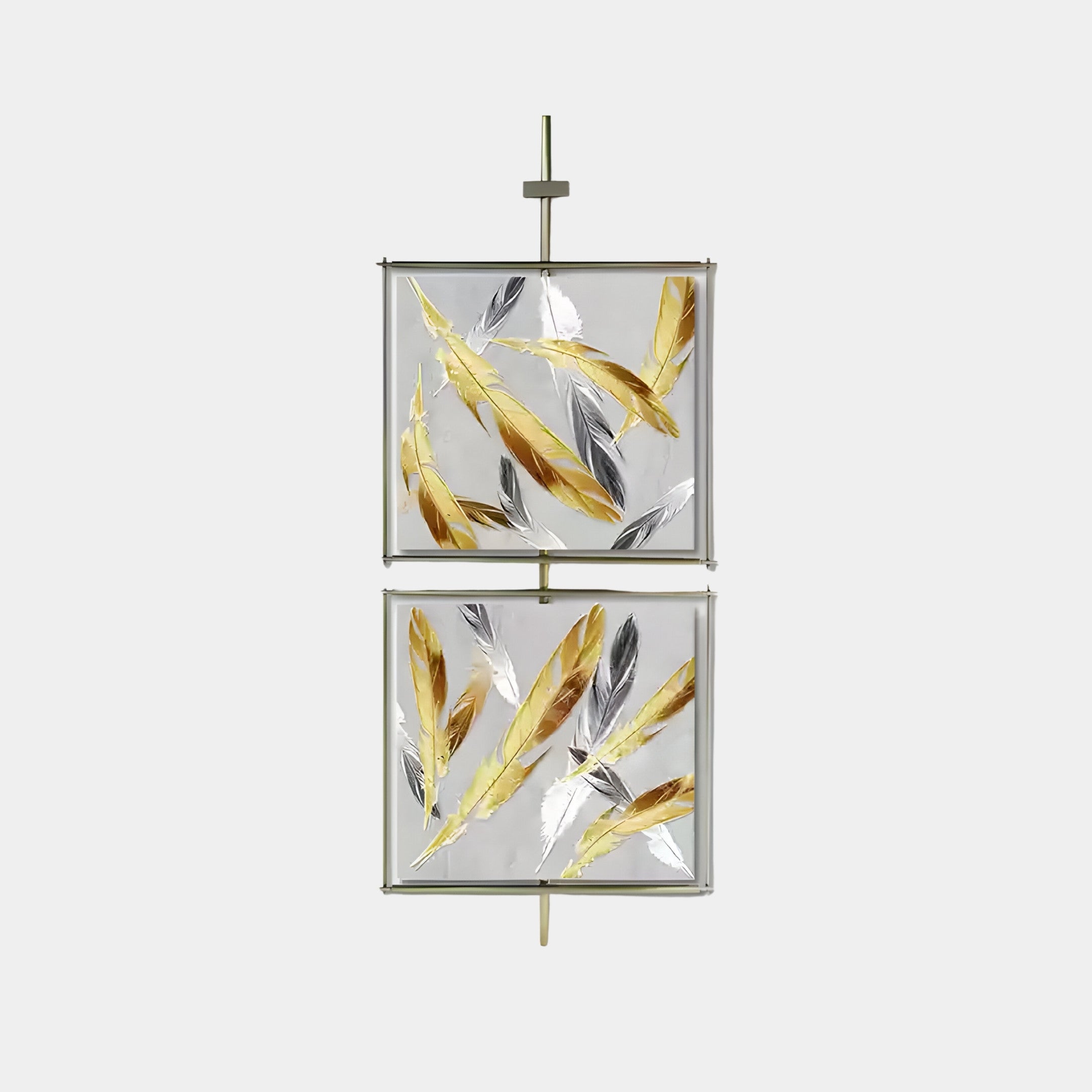 Giant Sculptures Vortice Feather Elegance Dual Panel Wall Art features metallic gold and silver feather motifs artistically arranged on a light background. Mounted vertically on a central rod, this piece captures the eye with its symmetrical and elegant design.