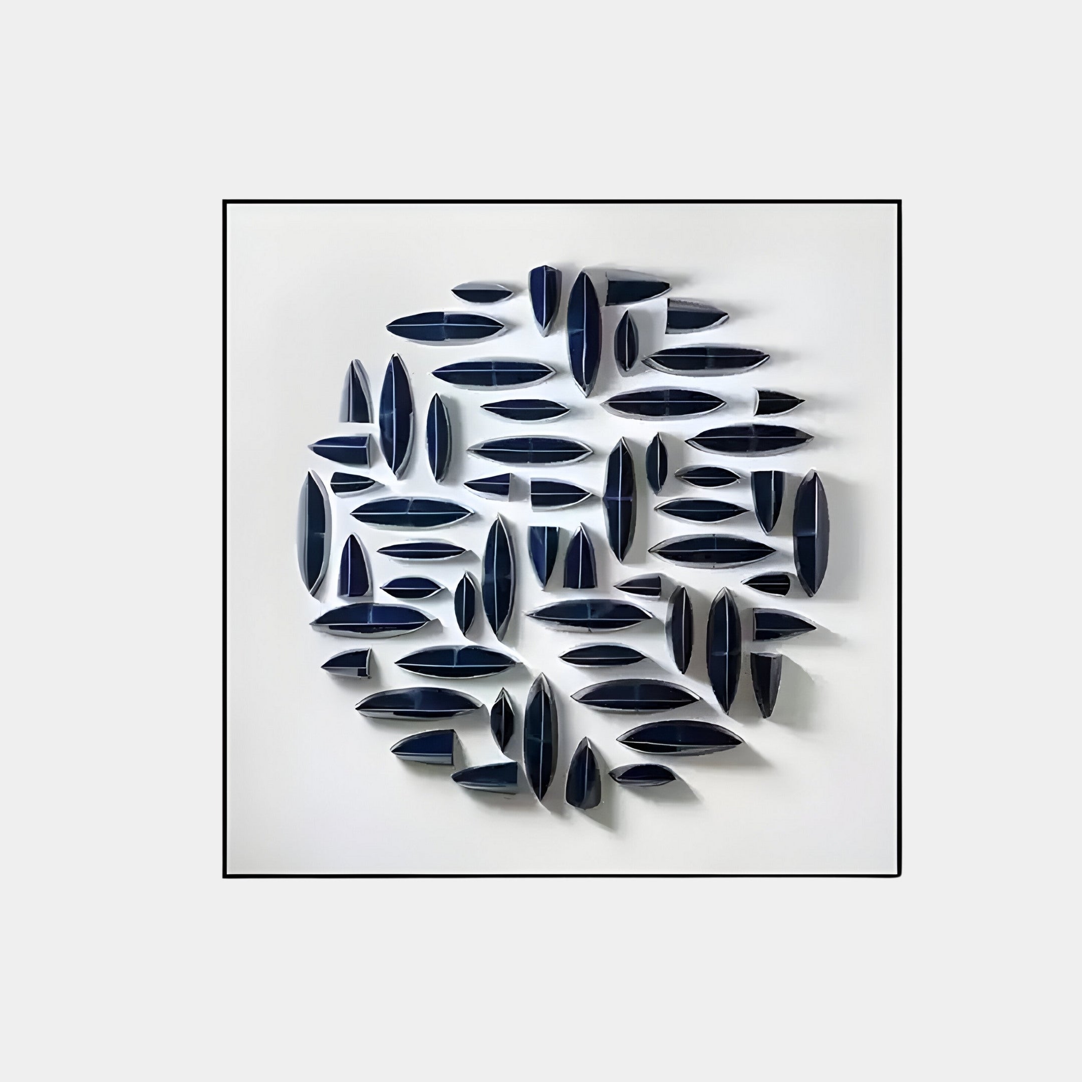 Modern 3D wall sculpture featuring glossy navy blue ceramic shapes arranged in a circular abstract pattern on a white background. A sophisticated art piece for contemporary interiors.