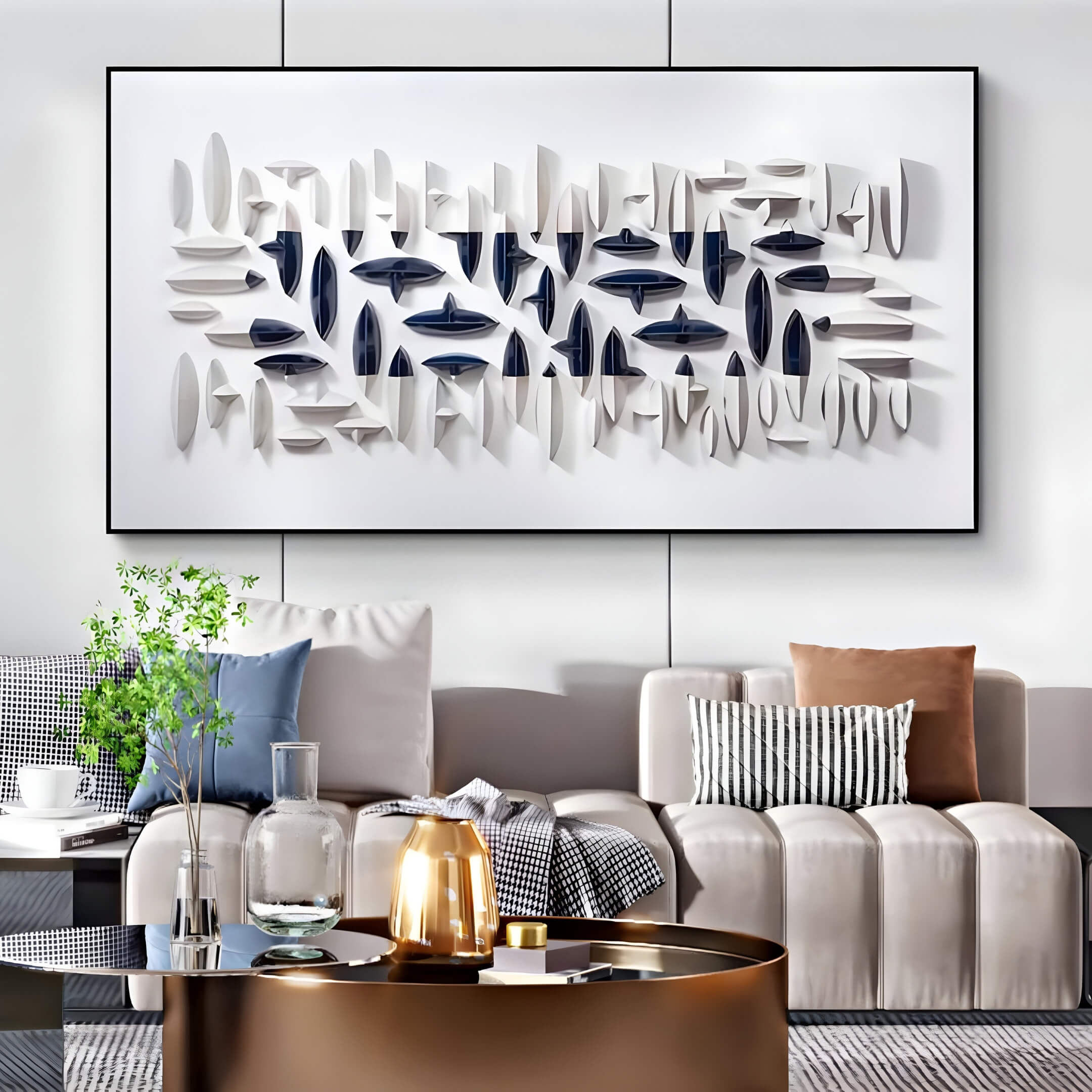 In a modern living room, a beige couch pairs with a round metallic coffee table. The wall showcases the Giant Sculptures Elysian 3D Ceramic Wall Art in Horizontal Layered Design, featuring geometric patterns in white, gray, and blue. Accents of greenery in a vase and decorative pillows complete the decor.