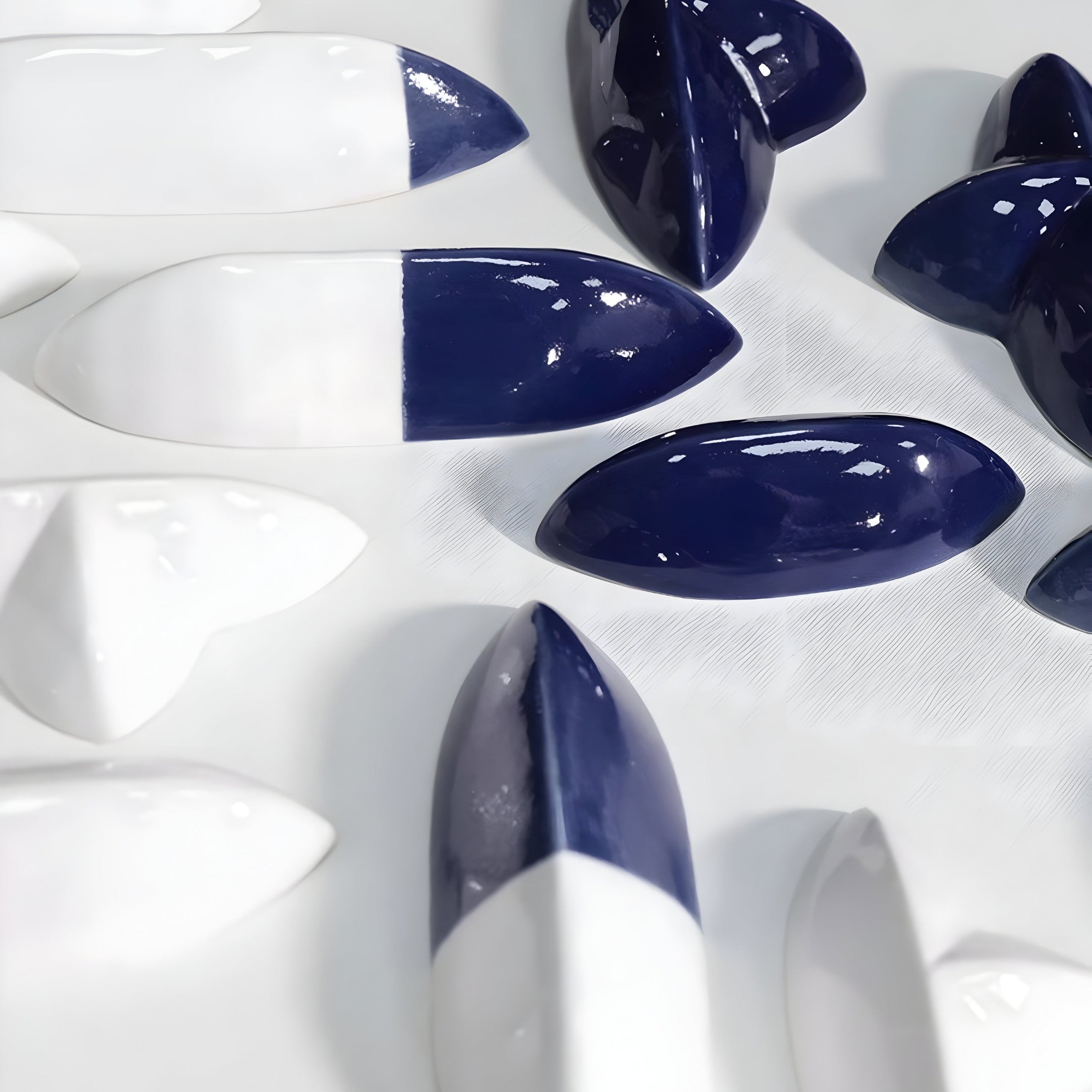 Detailed view of navy blue and white ceramic elements arranged in a geometric pattern. The smooth, glossy textures emphasize the contemporary design of the sculpture.