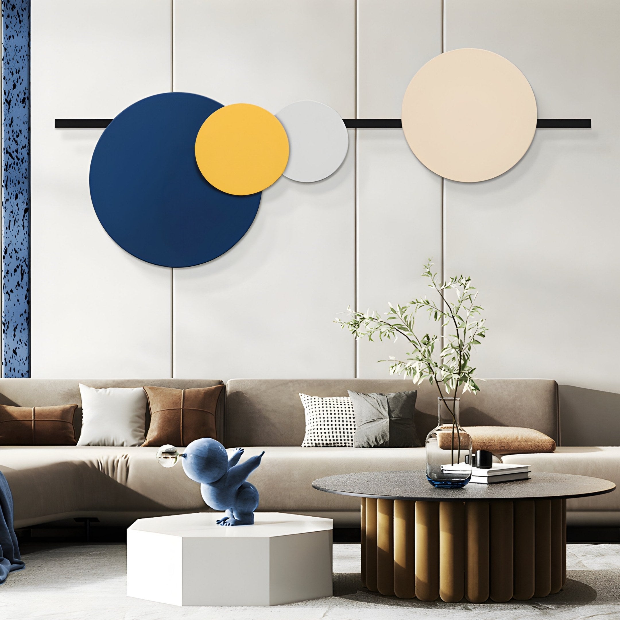 A modern living room features a brown sectional sofa under the Orbit I Radiant Balance Wall Art by Giant Sculptures, boosting its geometric flair. A round ribbed-base coffee table sits on a chic rug, with a small octagonal side table displaying a blue abstract sculpture, and a plant adds greenery.