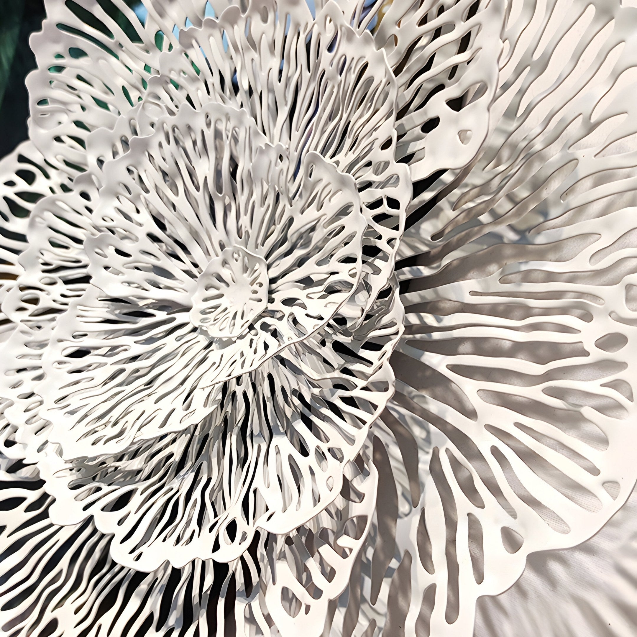 Nova Floral Radiant Emerald Green Circular Wall Art by Giant Sculptures features intricate white paper layers resembling petals or coral against an emerald green backdrop. The detailed cut-out designs add texture and elegance, enhancing luxury interiors with its floral art aesthetic.