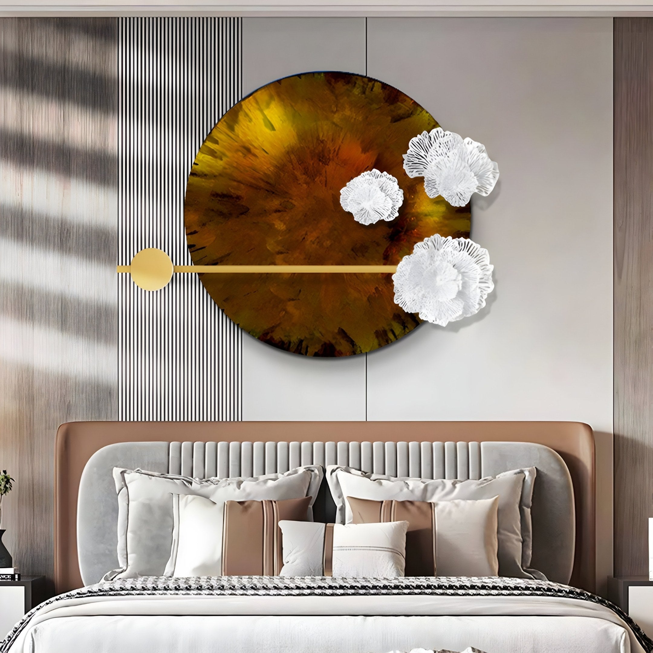 In a contemporary bedroom, a chic bed in beige and white bedding with decorative pillows is enhanced by the Nova Floral Radiant Amber Circular Wall Art from Giant Sculptures. This golden and white textured piece perfectly complements the striped wall, adding elegance to the modern decor.