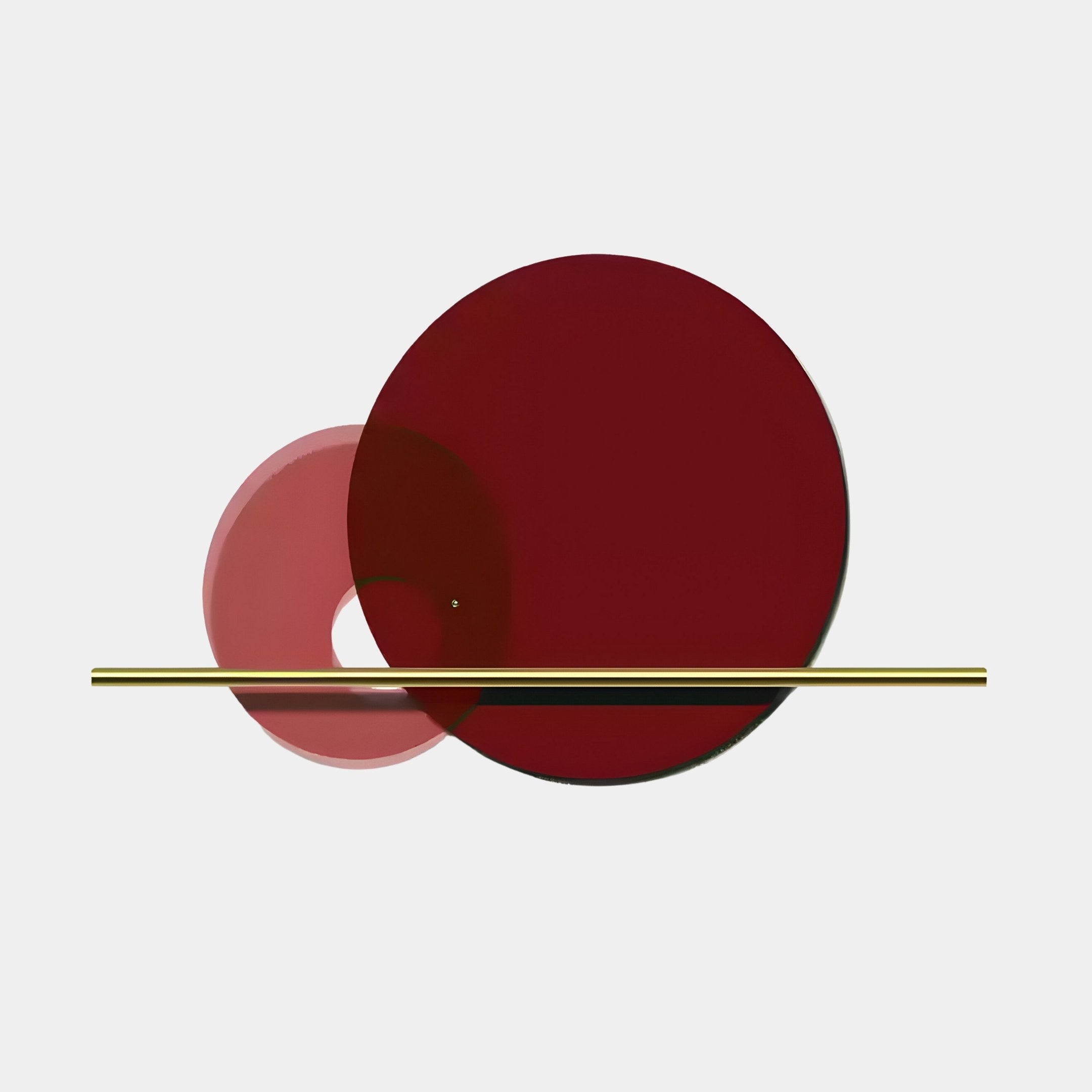 The Luna Forma Scarlet Red Round Brass Accent Wall Art by Giant Sculptures is abstract geometric art featuring overlapping scarlet red and light pink circles intersected by a gold bar on a white background.