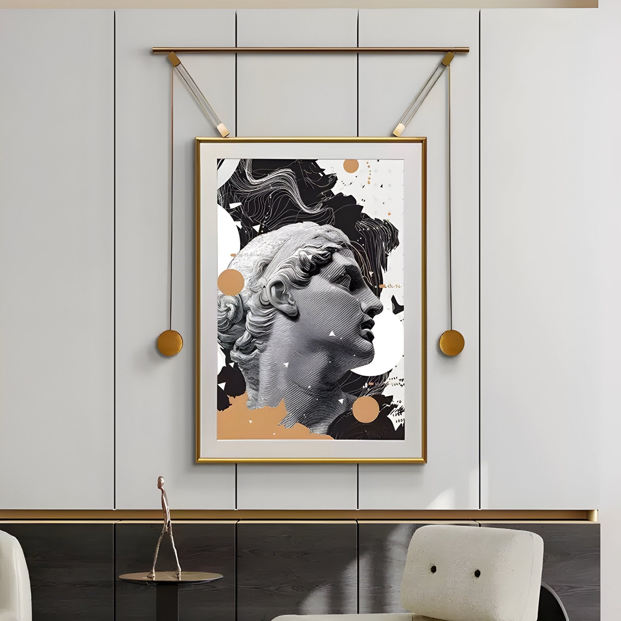 The Eterna Classics David Replica Portrait by Giant Sculptures, featuring a modern black and white design with gold accents, is elegantly framed in gold and hung on a light gray wall. Displayed above a dark cabinet with a decorative branch sculpture, it enhances the classical art ambiance.