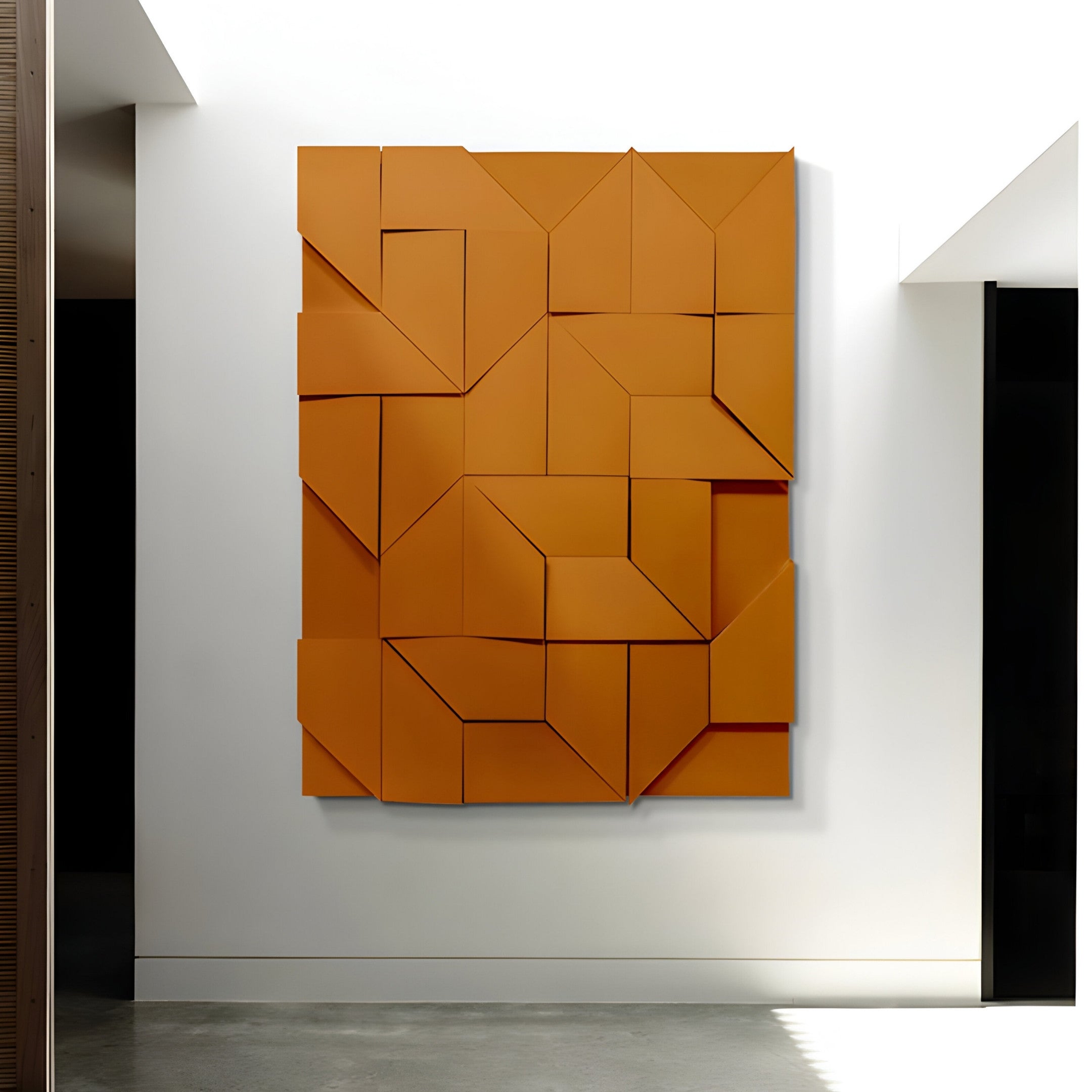 The Prisma Orange Geometric Panel 3D Wall Art by Giant Sculptures showcases a striking three-dimensional interlocking design on a white wall, embodying modern architectural style and minimalist aesthetics.