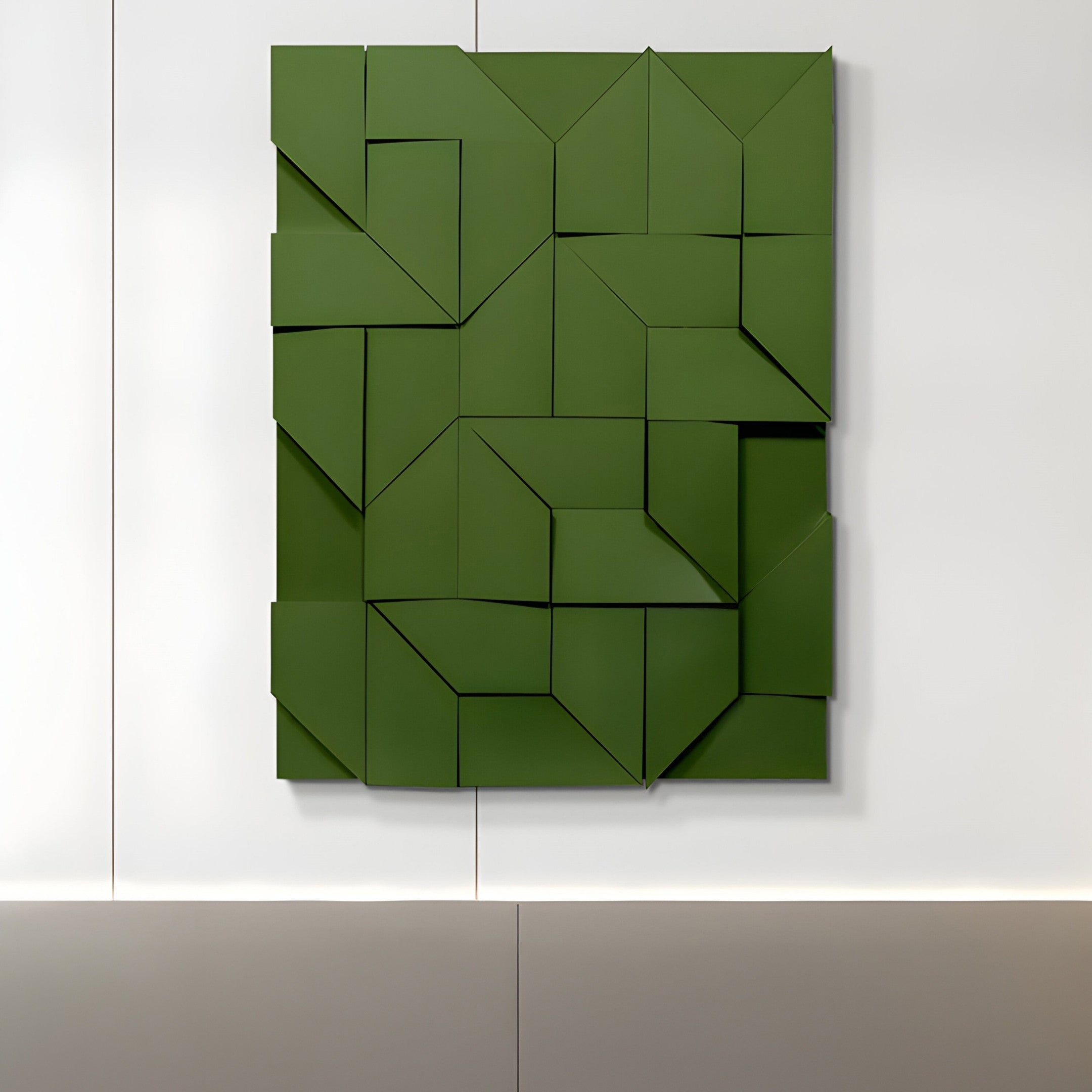 The Giant Sculptures Prisma Green Geometric Panel 3D Wall Art, featuring interlocking triangular and rectangular shapes, mounts on a white wall. The three-dimensional design casts subtle shadows, enhancing any interior space.