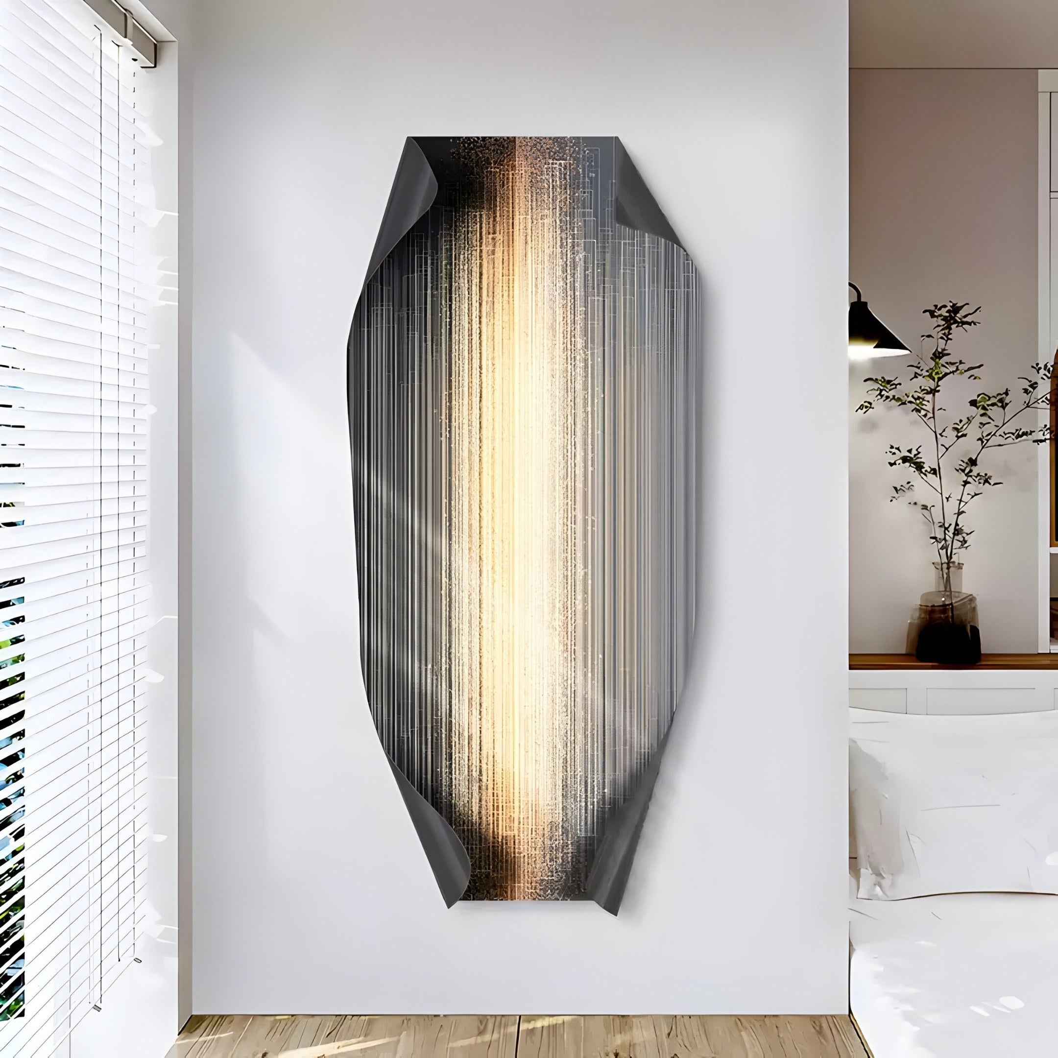 The minimalist room gains contemporary elegance with the Celestial Gold Radiance Edge Folded Abstract Metal Wall Art by Giant Sculptures, featuring a vertical oval shape, metallic textures, and central glow. Natural light through blinds highlights a potted plant beside the bed.