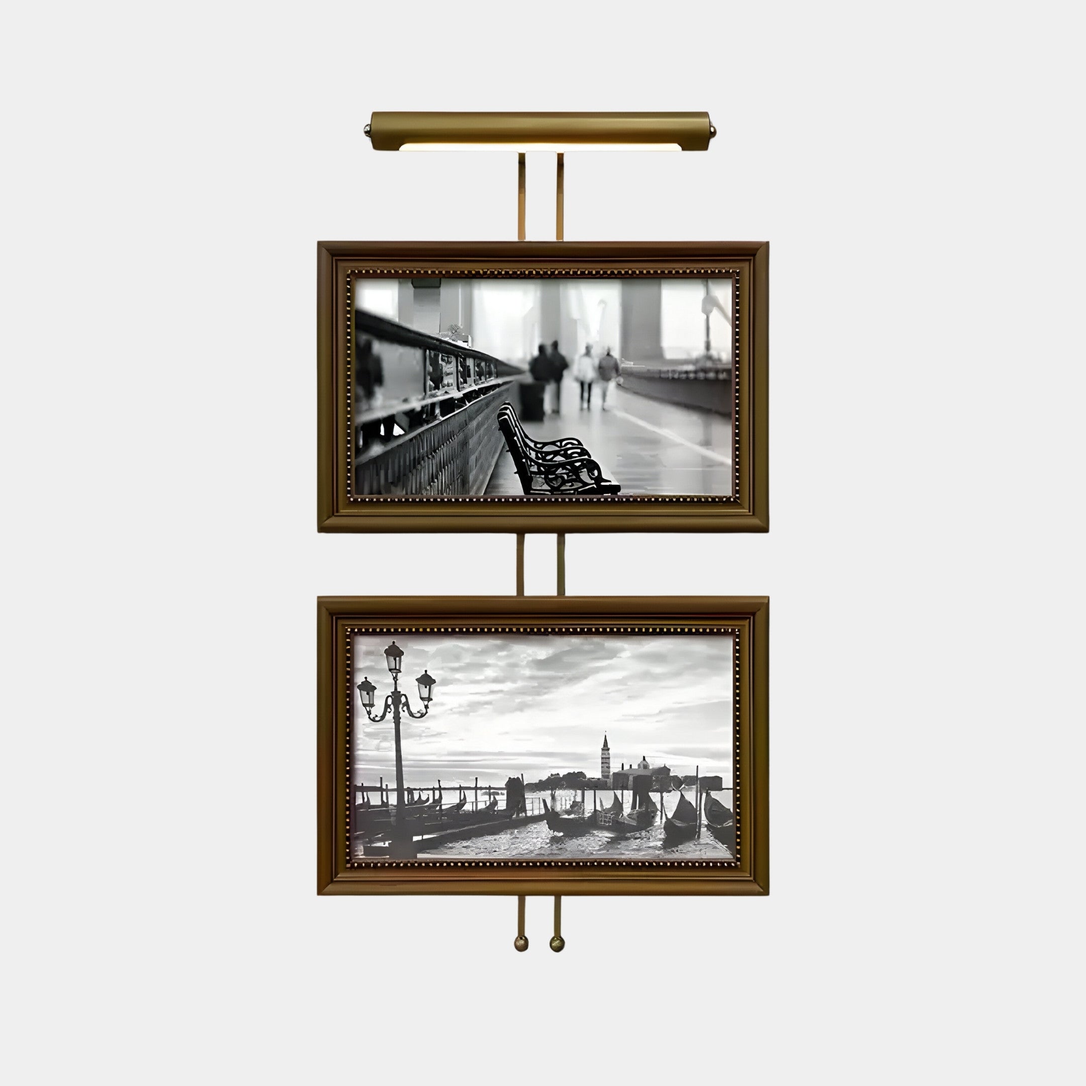 The Artisera Venetian Promenade Classic Dual Frame Built-In Light Wall Art by Giant Sculptures features wall-mounted displays in antique gold frames, showcasing a blurred black-and-white photo of park benches and a scenic waterfront with lampposts and gondolas.