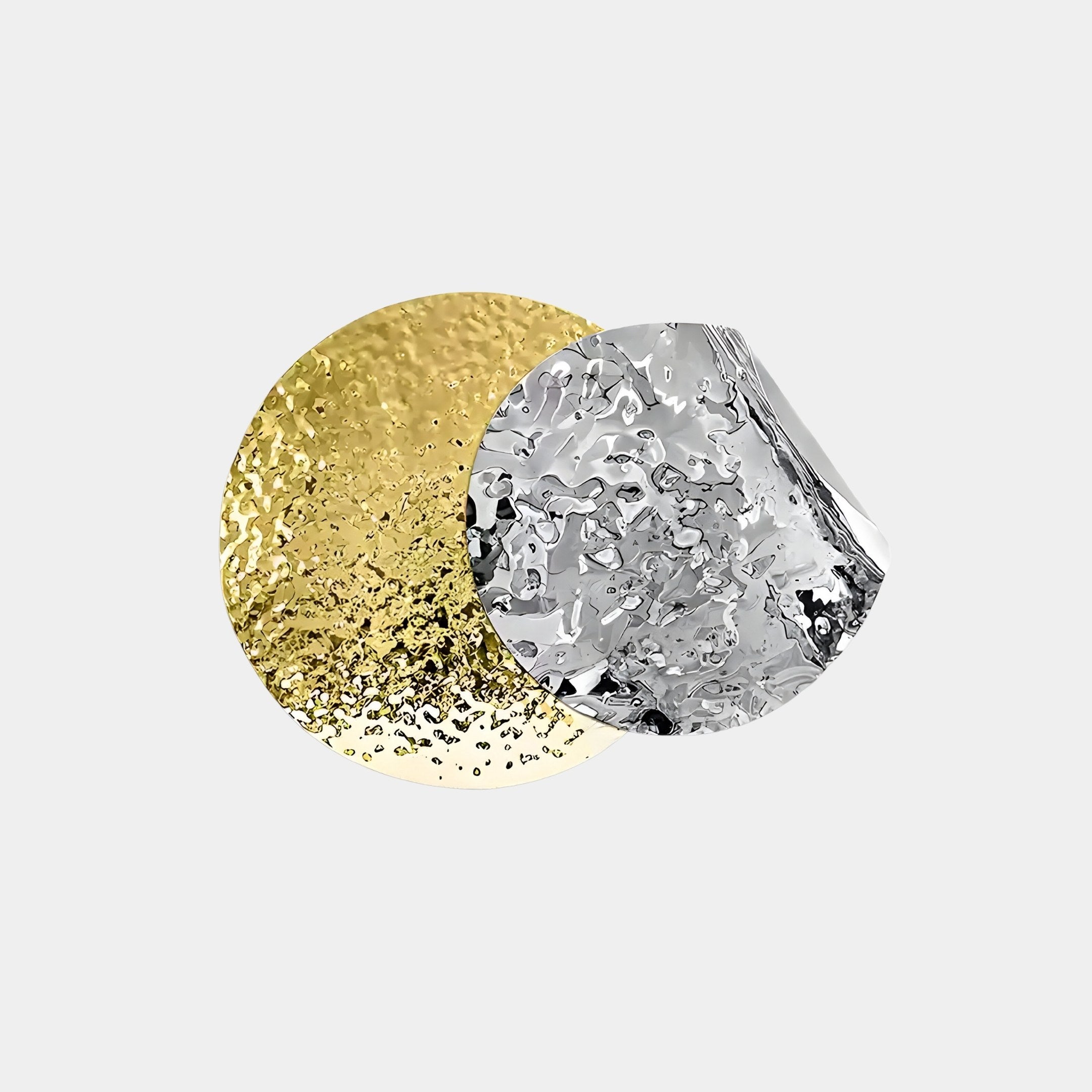 The Metaluxe IV Gold & Silver Dual Disc Textured 3D Wall Art by Giant Sculptures features two textured overlapping circles, one gold and one silver, creating a striking modern statement against a plain surface.