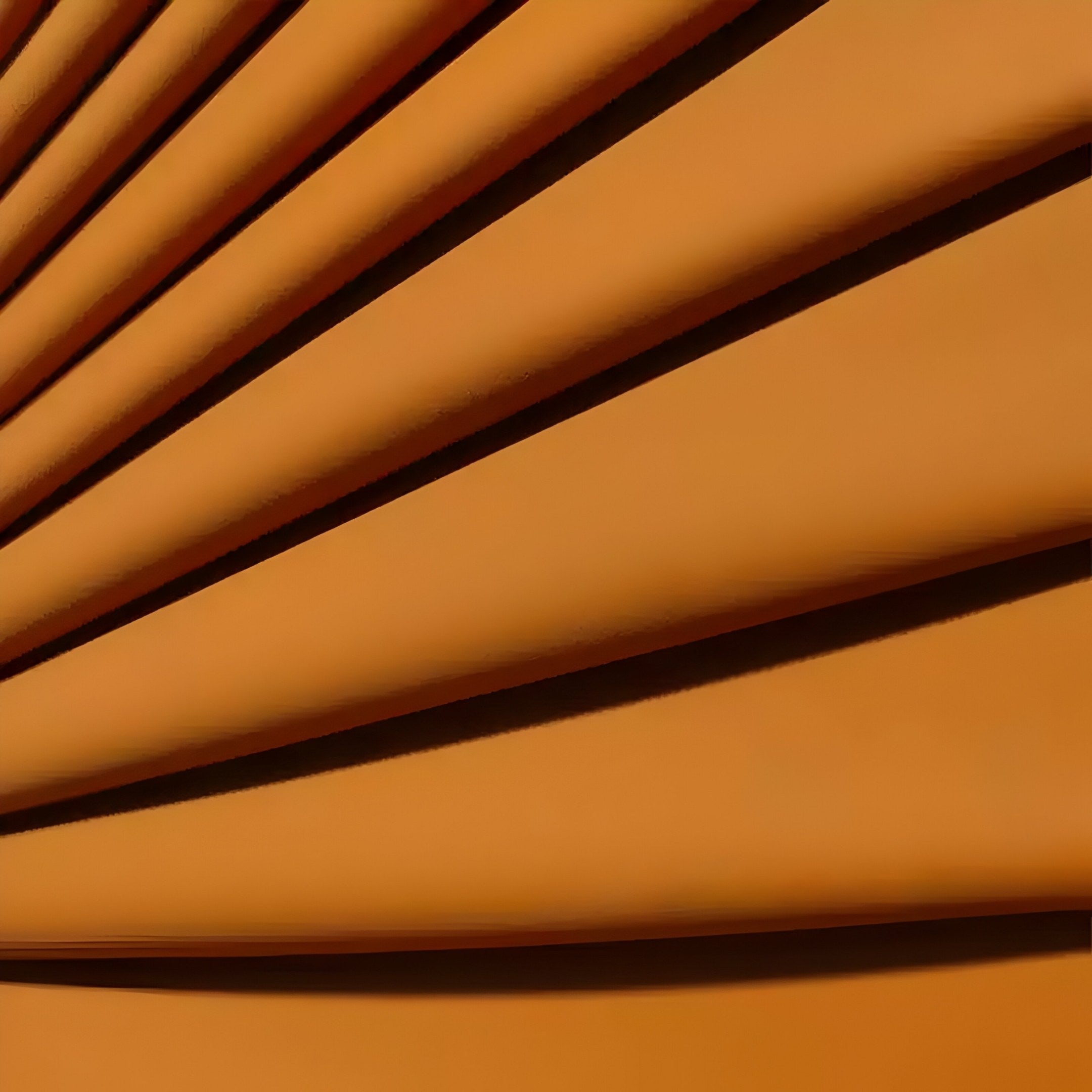 The Giant Sculptures Auramesh Sunset Orange-I Metal Winged Circular Geometric Wall Art showcases an intricate pleated pattern with elegant diagonal lines. Soft shadows enhance the depth and texture, making it a striking piece of contemporary home decor.