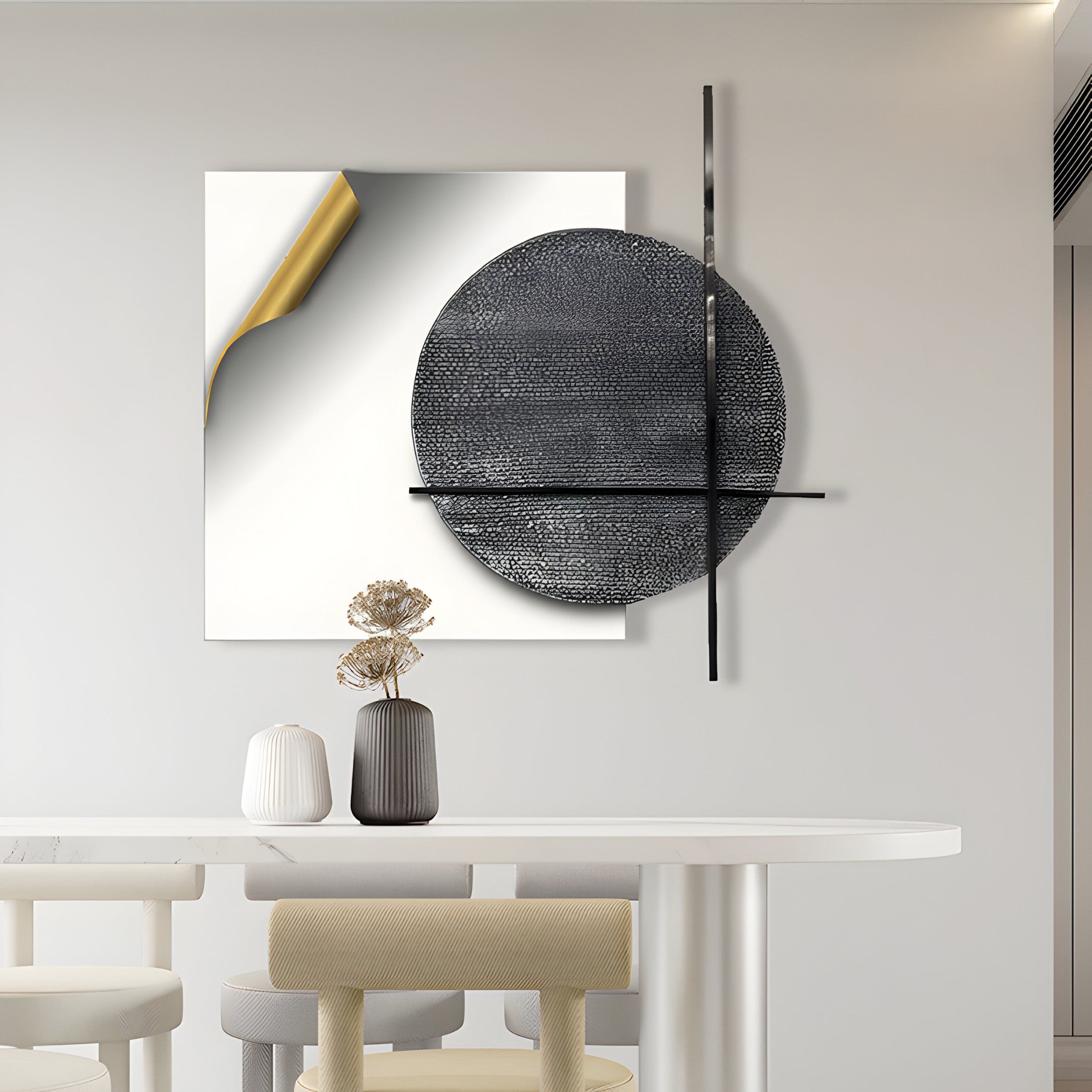 A minimalist interior features a white table with chairs, two vases (black and white) with dried flowers, and the Tesselle White Metal Fold & Grey Textured Geometric Wall Art from Giant Sculptures. This wall art includes a gold-accented canvas and textured circular elements.