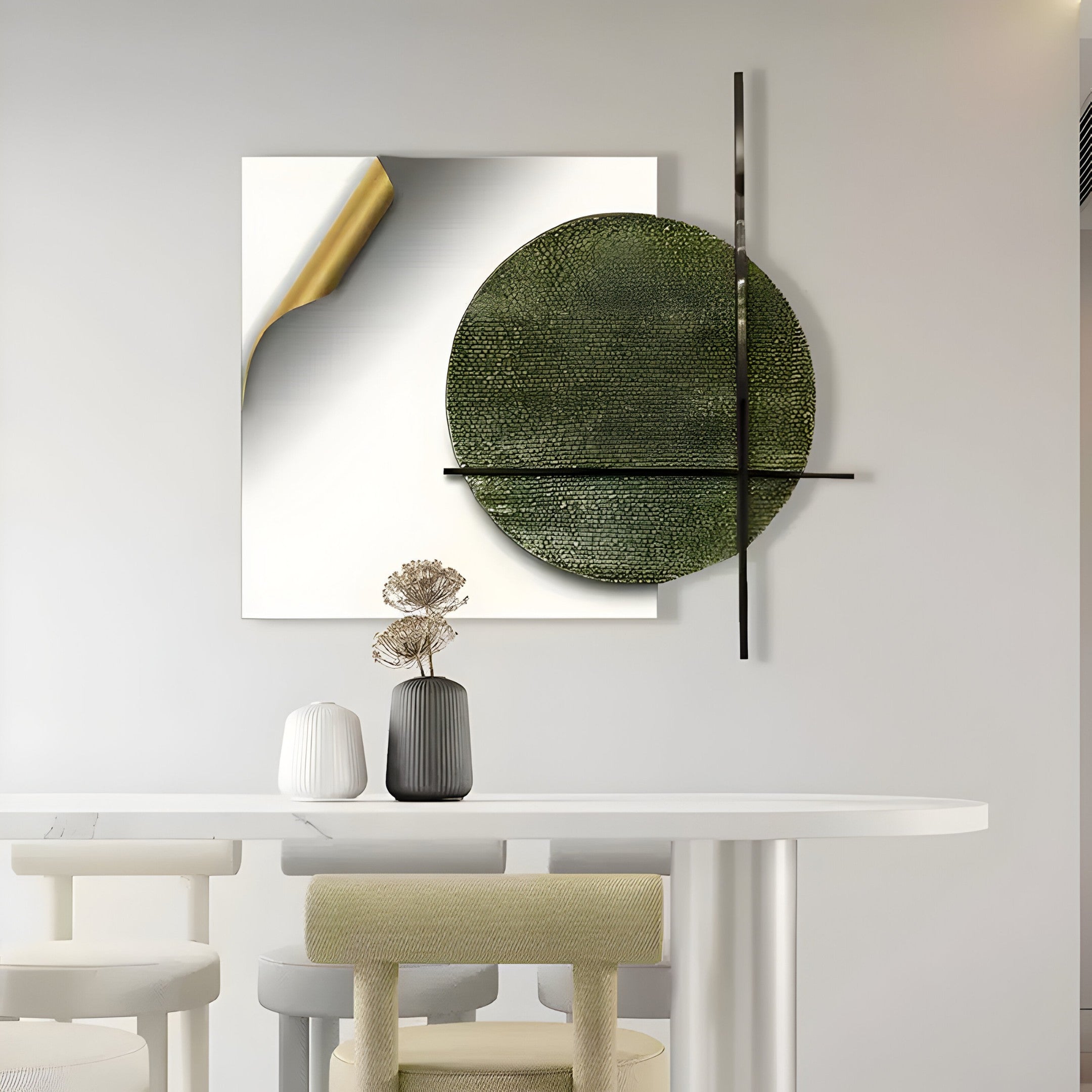 The minimalist dining space features Tesselle White Metal Fold & Green Textured Geometric Wall Art by Giant Sculptures, showcasing a green textured circle intersected by black lines. A gold-accented square complements this art piece, enhancing the table, which is adorned with two decorative vases.