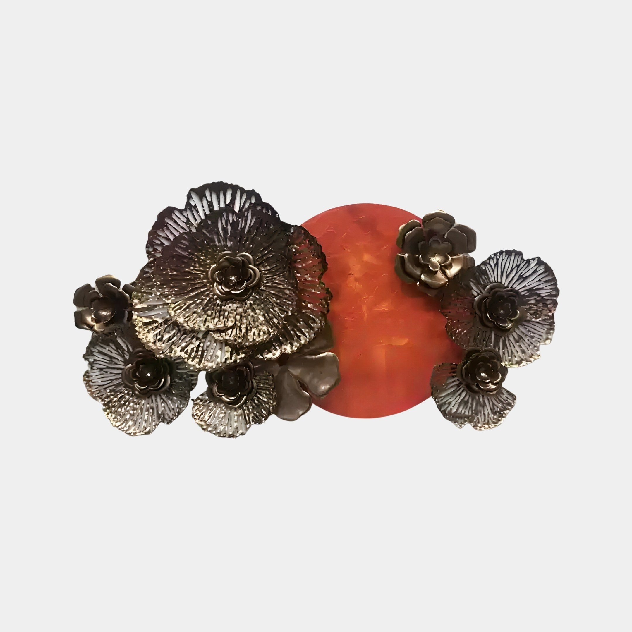 The Luminis Bloom Red Floral Metal Wall Art by Giant Sculptures features bronze flowers with metallic petal shapes around a circular, fiery orange-red disc, creating artistic contrast between intricate details and the smooth, vibrant centerpiece.