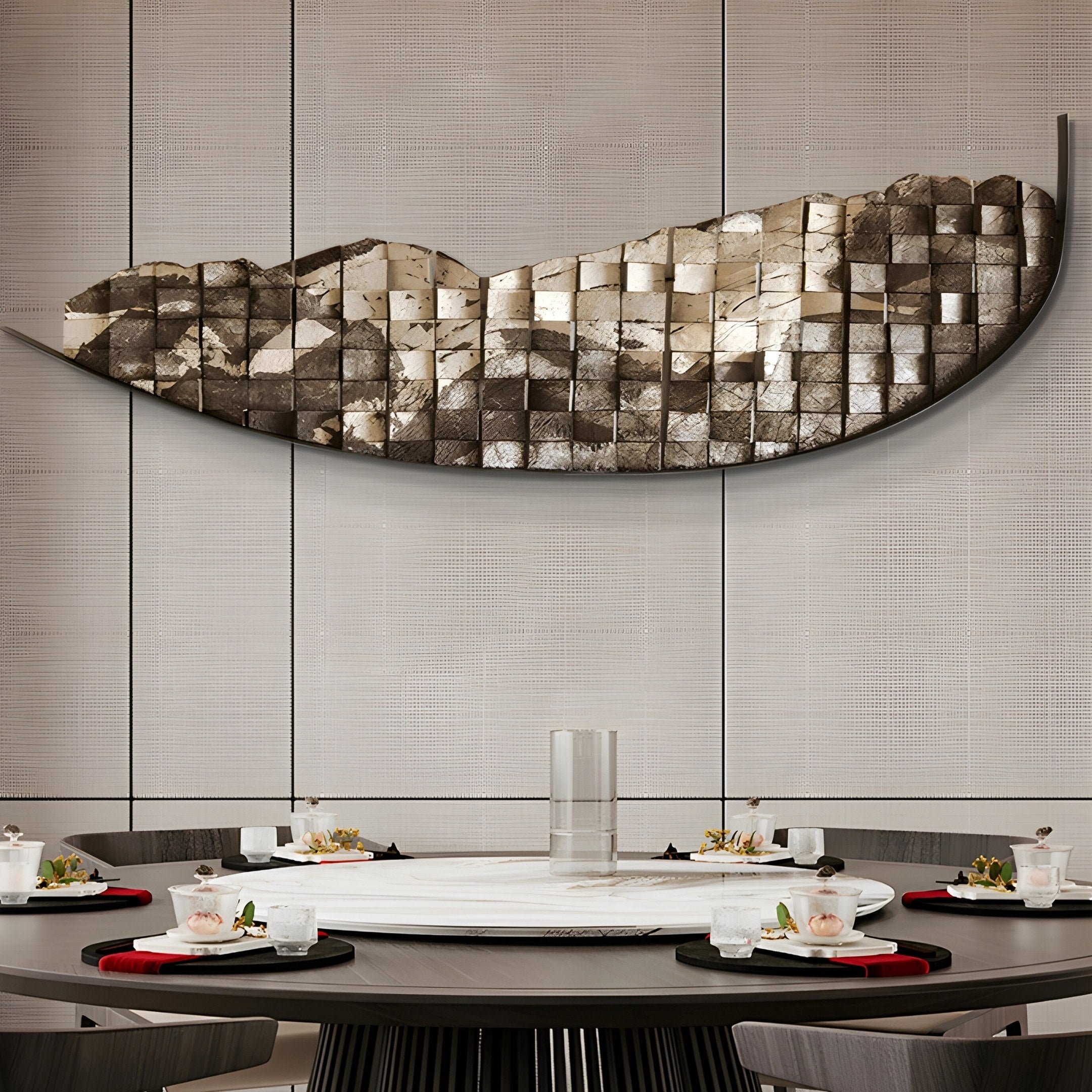 The modern dining room showcases a round table for four, adorned with black and red accents. Above it hangs the Arcana Metallic Earth Textured Mosaic Half-Moon 3D Wall Art by Giant Sculptures, featuring a striking curve of square tiles. The setting is elegantly minimalistic.