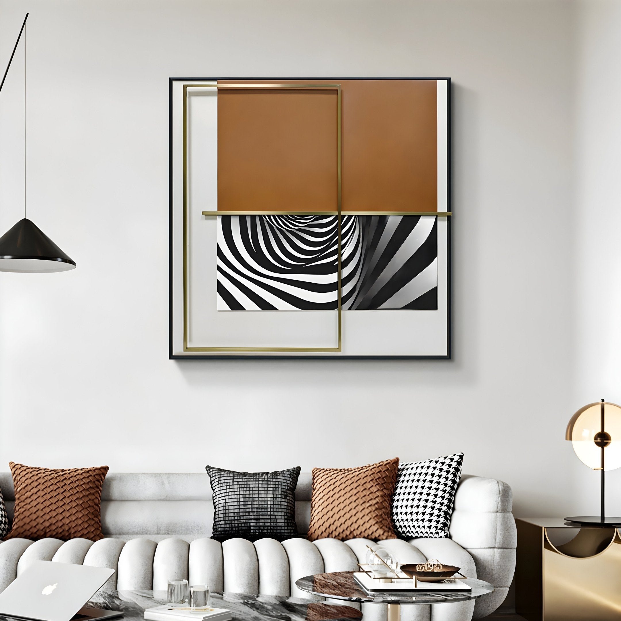 A modern living room features a white tufted sofa with patterned cushions in black, white, and brown. The Optique Warp Black & Brown Square Wall Art by Giant Sculptures hangs above, boasting geometric shapes and a B&W spiral design. A sleek pendant light and stylish decor add contemporary flair.