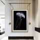 The Glacia Jellyfish Crystal Hanging Framed Wall Art by Giant Sculptures, with its vibrant hues and tentacles, adorns a modern white-paneled wall in a sleek room, enhancing the minimalist decor alongside an expansive left window.