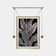 The Glacia Monochrome Botanical Crystal Hanging Framed Wall Art by Giant Sculptures showcases a contemporary black-and-white leaf design. Suspended by rods and round weights within a gold frame against a gray backdrop, it exemplifies modern elegance.