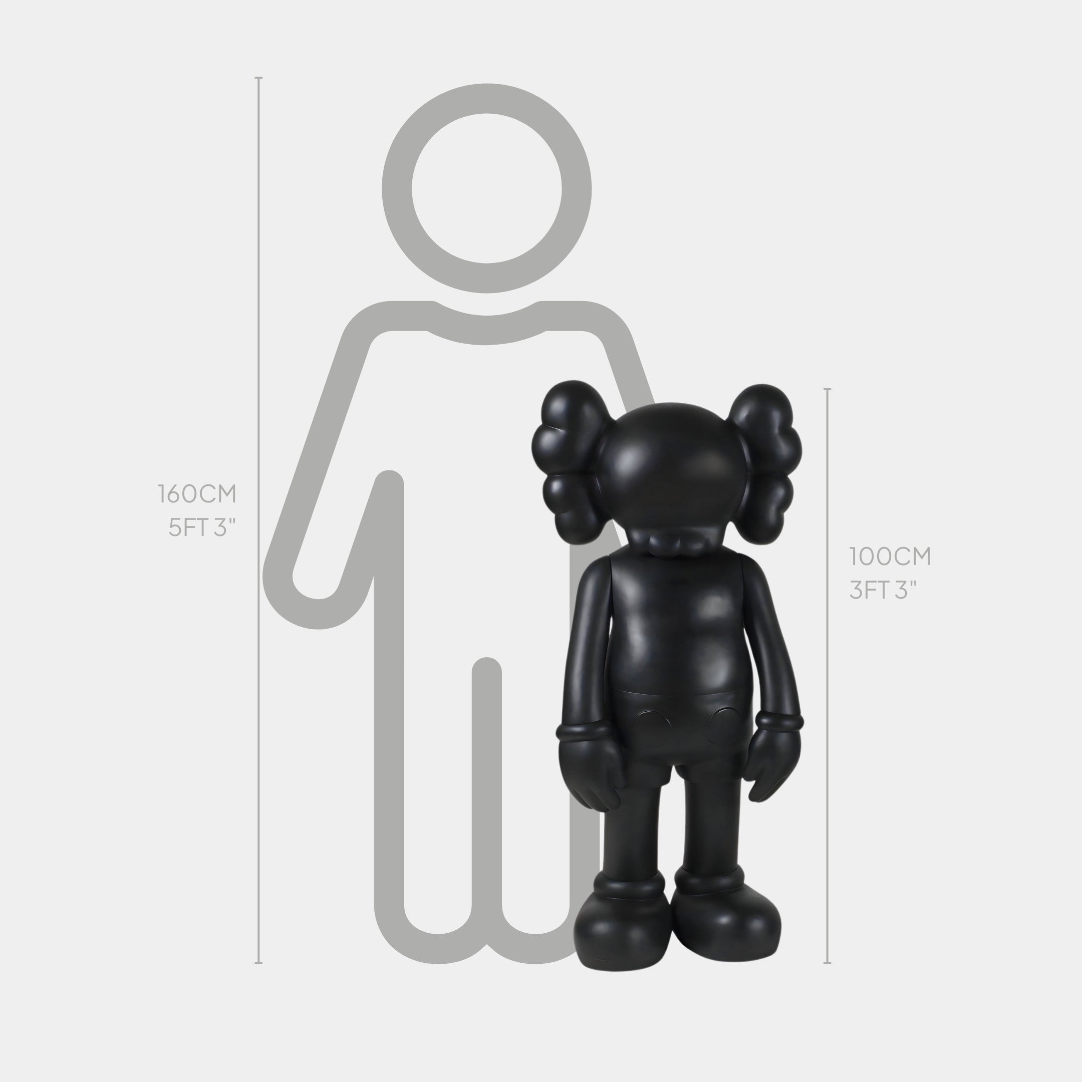 The Midnight Black Iconify Standing Sculpture by Giant Sculptures, at 100 cm tall, stands in cartoon style with crossed-out eyes. Positioned before a grey figure measuring 160 cm, it offers minimalist sophistication that highlights the height difference beautifully.