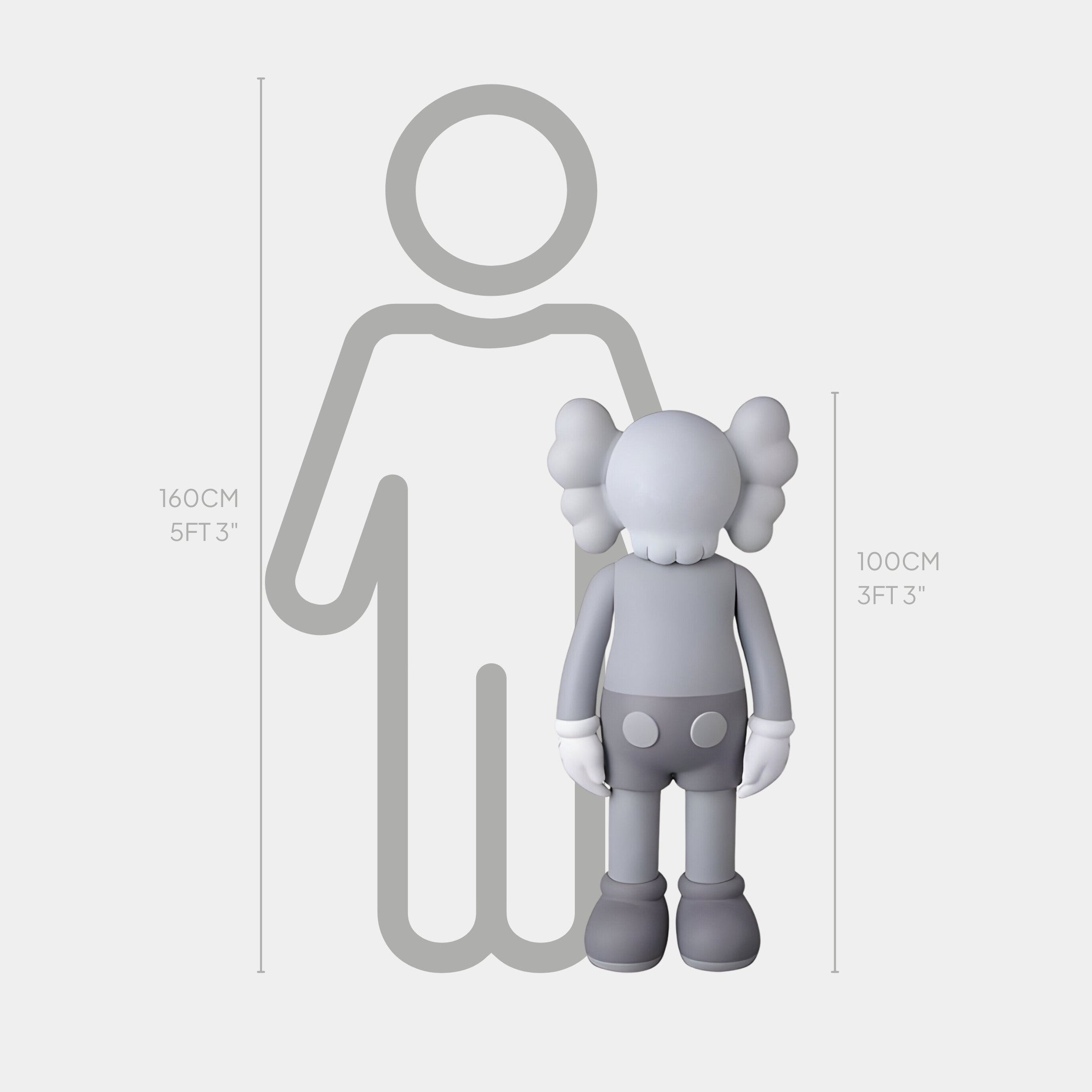 The Slay Grey Iconify Standing Sculpture by Giant Sculptures, at 100 cm tall, embodies minimalist elegance with distinct features. Its contemporary design is accentuated standing next to a 160 cm silhouette.