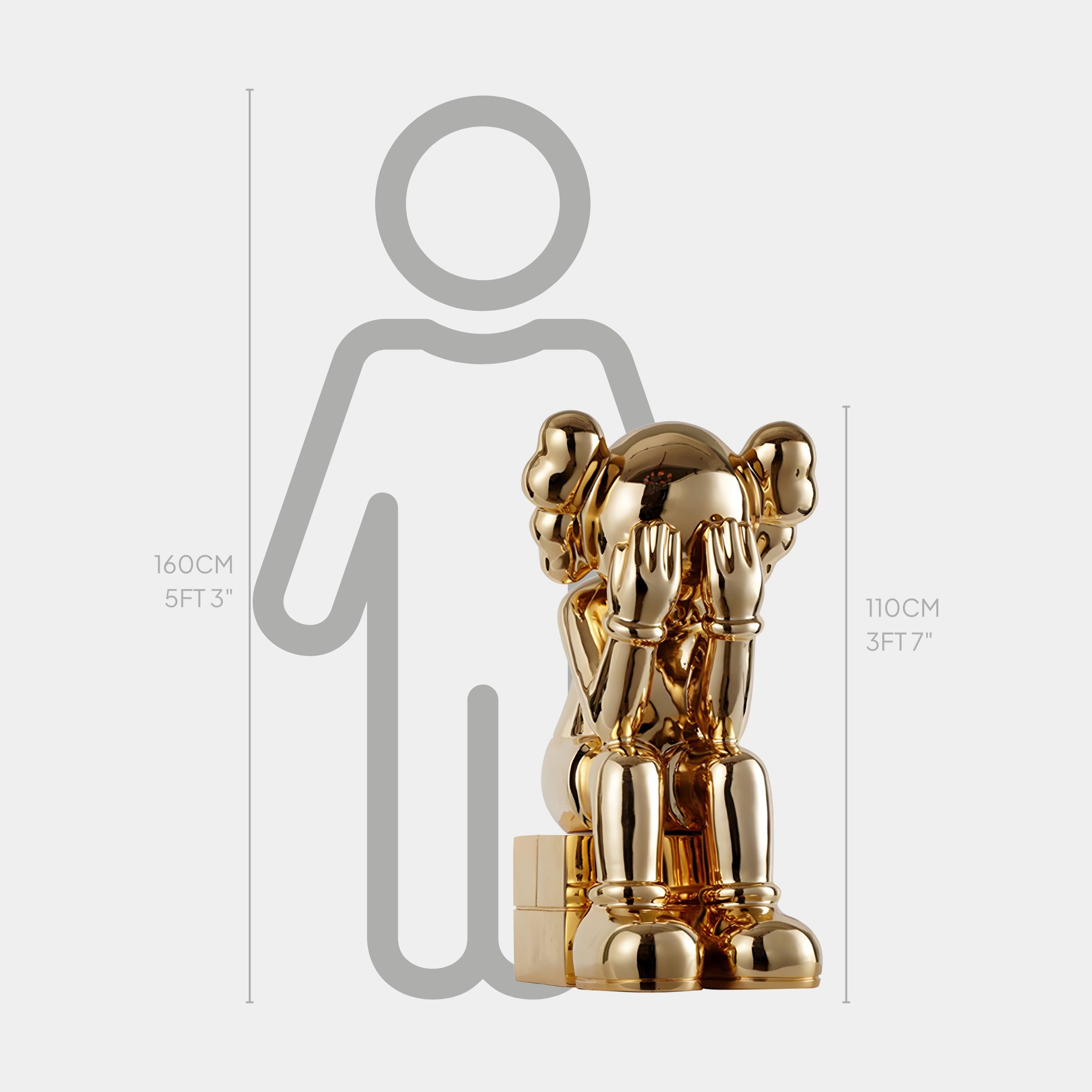 The Antique Gold Iconify Melancholy Sitting Sculpture by Giant Sculptures stands 110 cm tall and depicts a character with hands covering its face, making it a bold luxury decor piece. Positioned against a gray outline of a 160 cm person, it elegantly elevates any space.